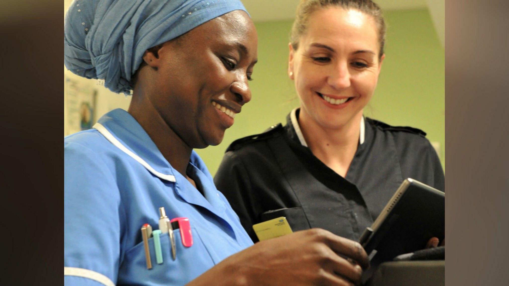Nurses looking at an Ipad 