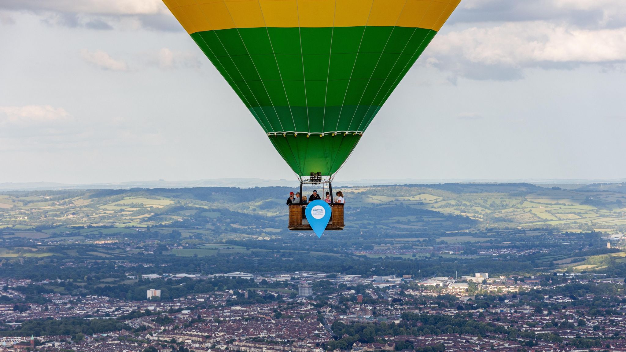 Image of people in a hot air balloon flying over Bristol