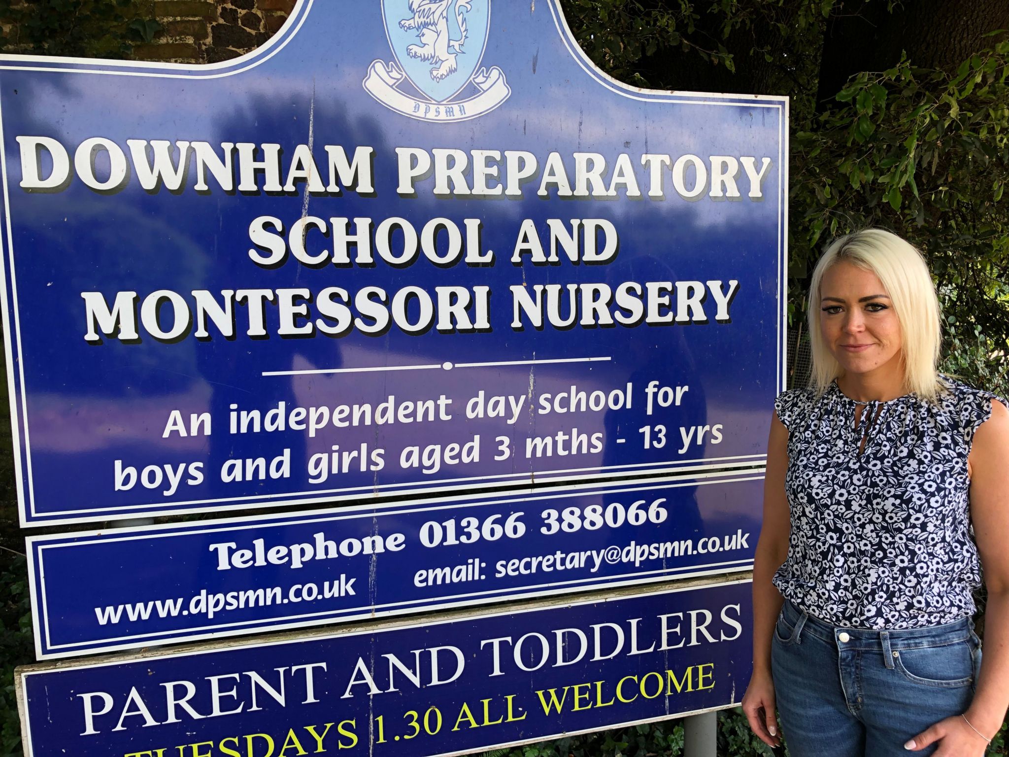 Parent Hannah Doy stands in front of the Downham Prep school sigh