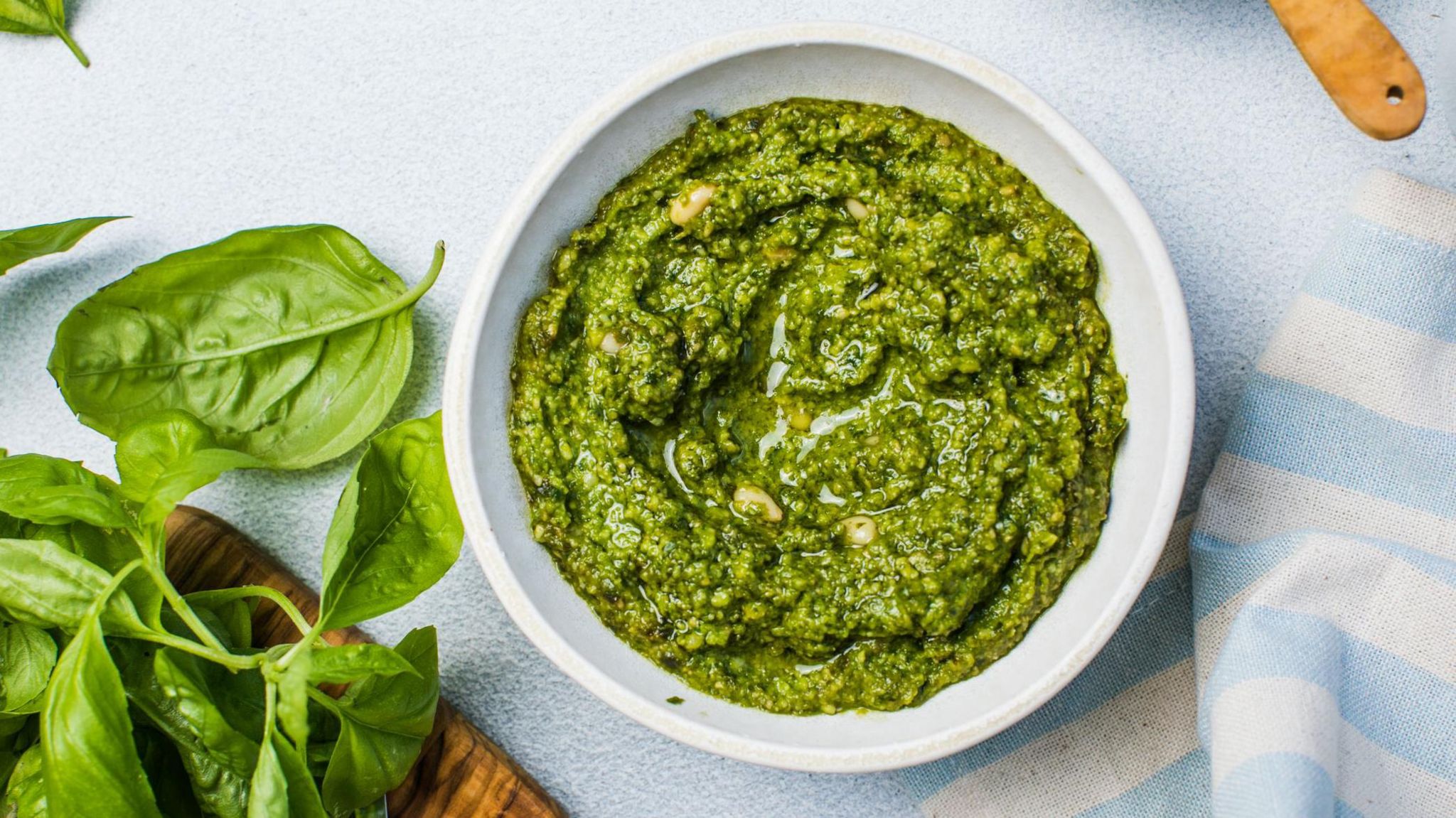 A bowl of fresh pesto, containing pine nuts, basil, garlic, oil and parmesan