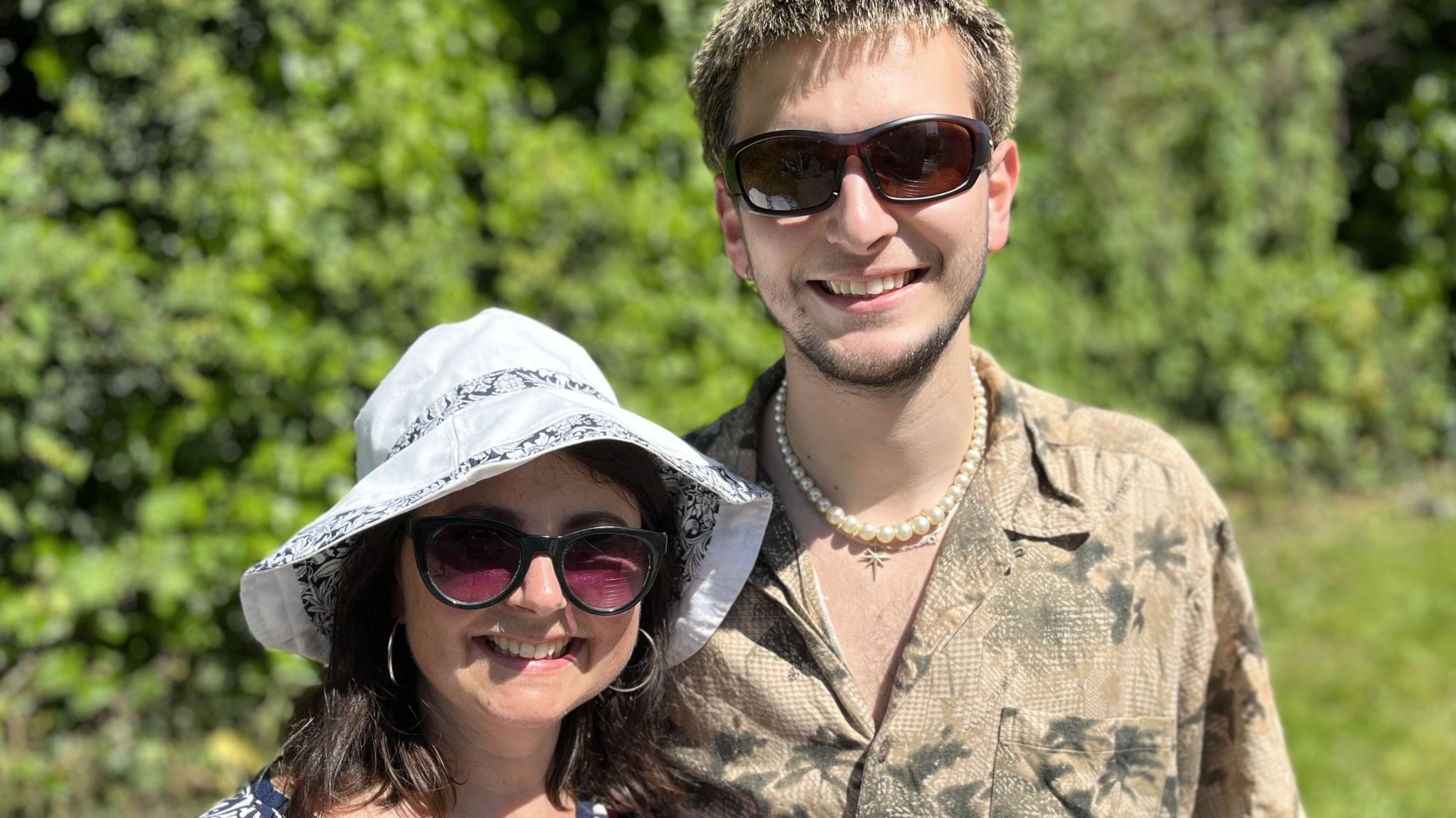 Mother and son, Rachel Huntley and Zac Lewis, smiling, both wearing sunglasses