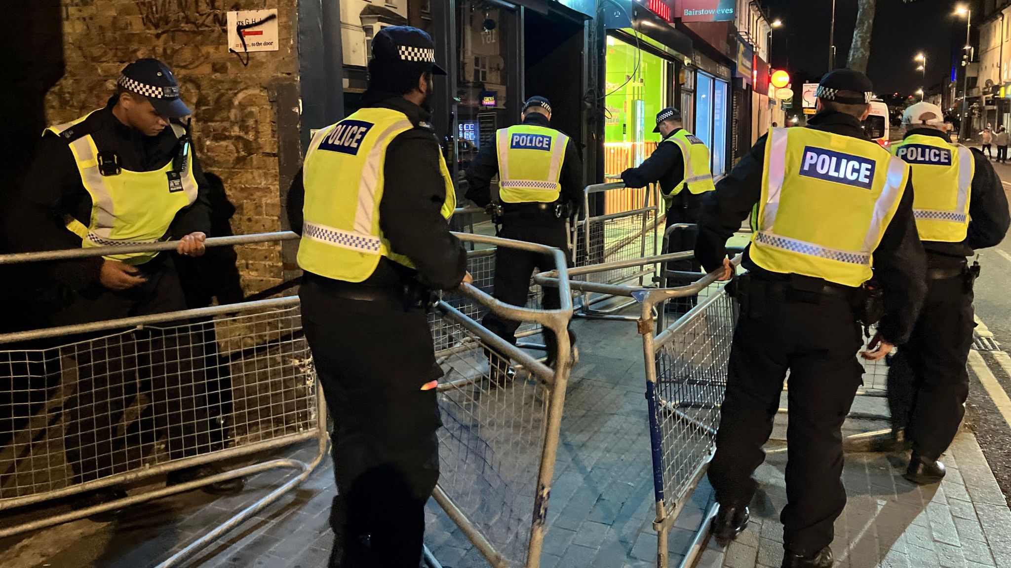 Police officers carry barriers