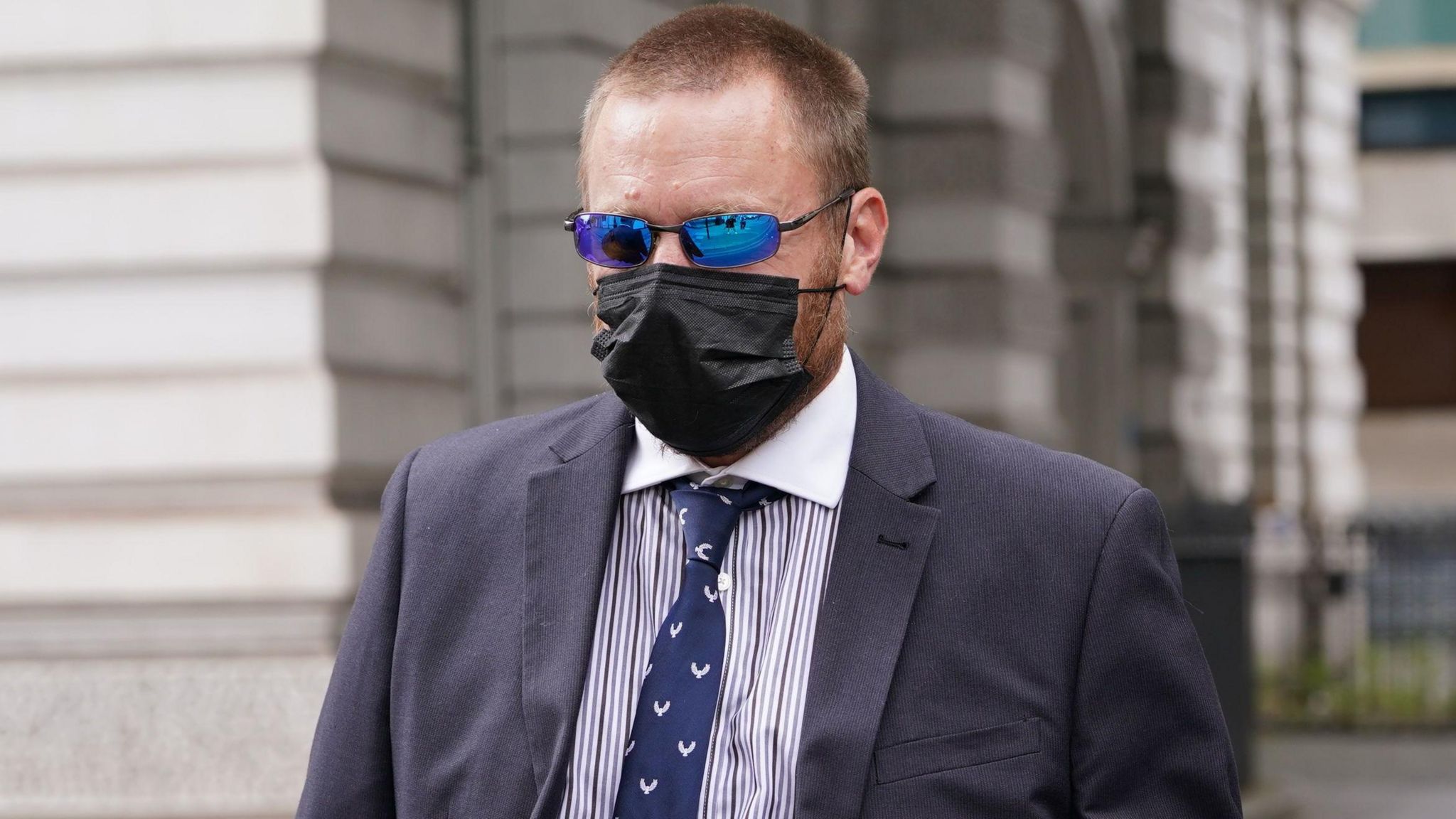 PC Craig Carter wearing a black face mask and sunglasses