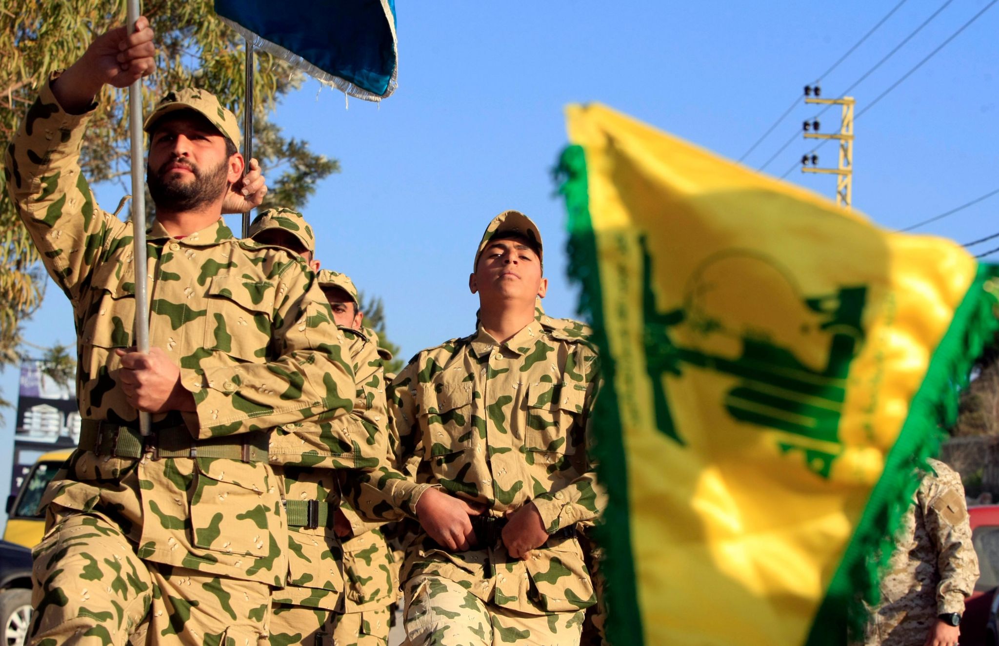 Hezbollah fighters parade during a ceremony to honor fallen comrades, in Tefahta village, south Lebanon, Saturday, Feb. 18, 2017.