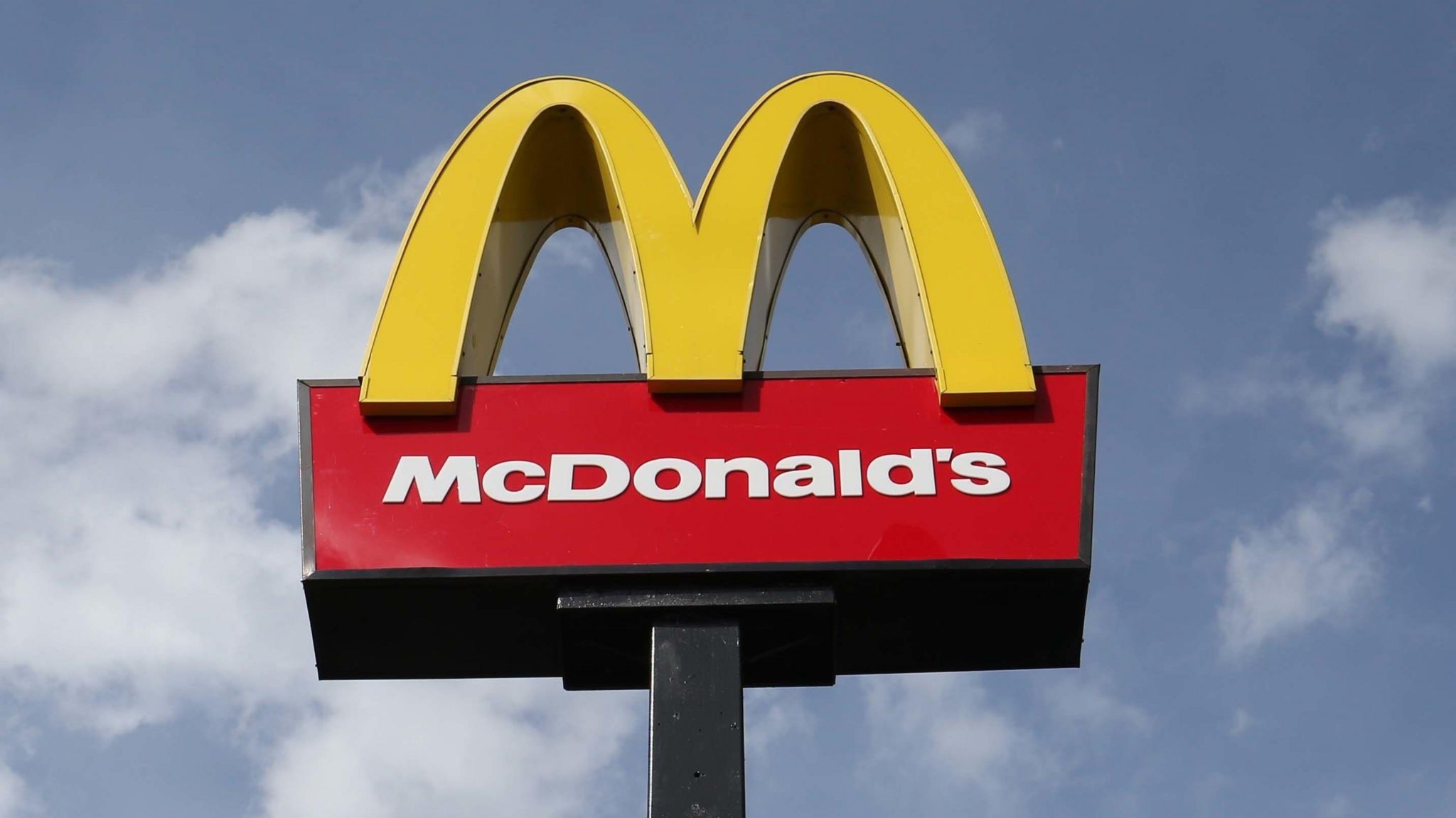 McDonald's sign set against a blue sky
