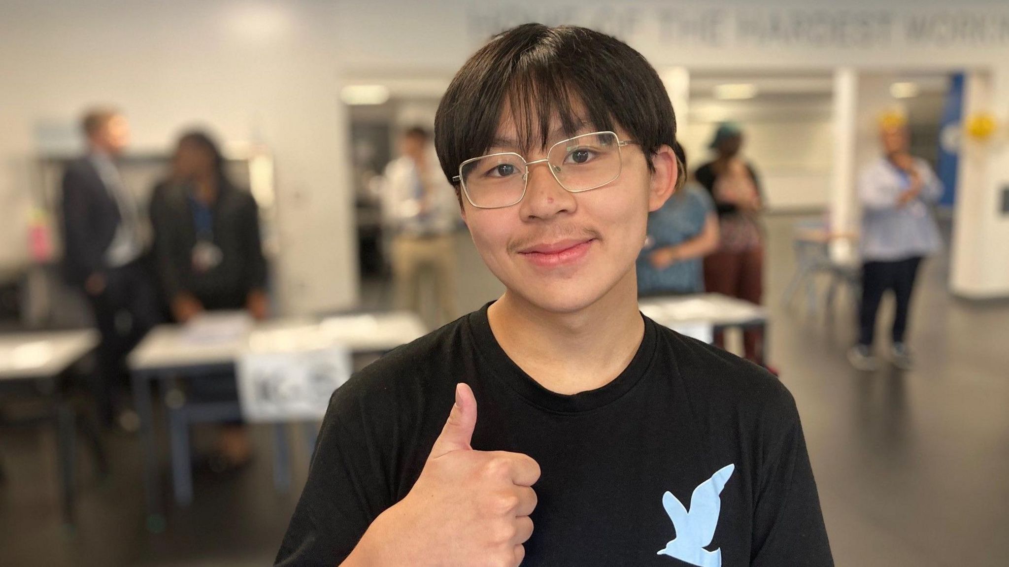 Lucas from Dixons Trinity Chapeltown with his thumb up celebrating his GSCE results