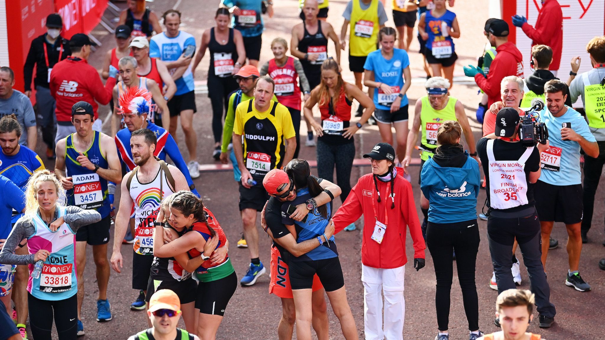 London Marathon runners celebrate crossing the finish line in 2021