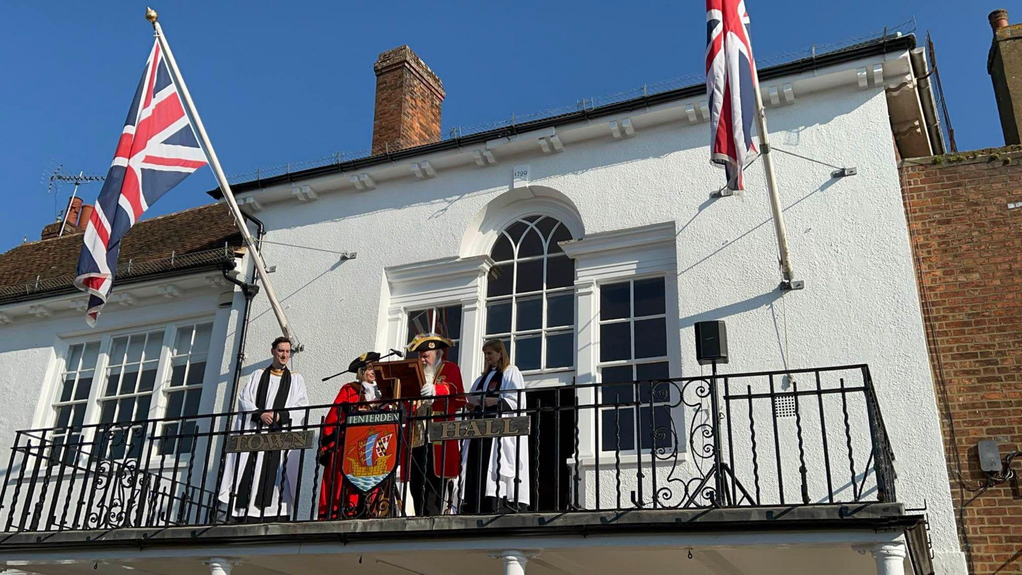 Tenterden's town crier on the town hall balcony