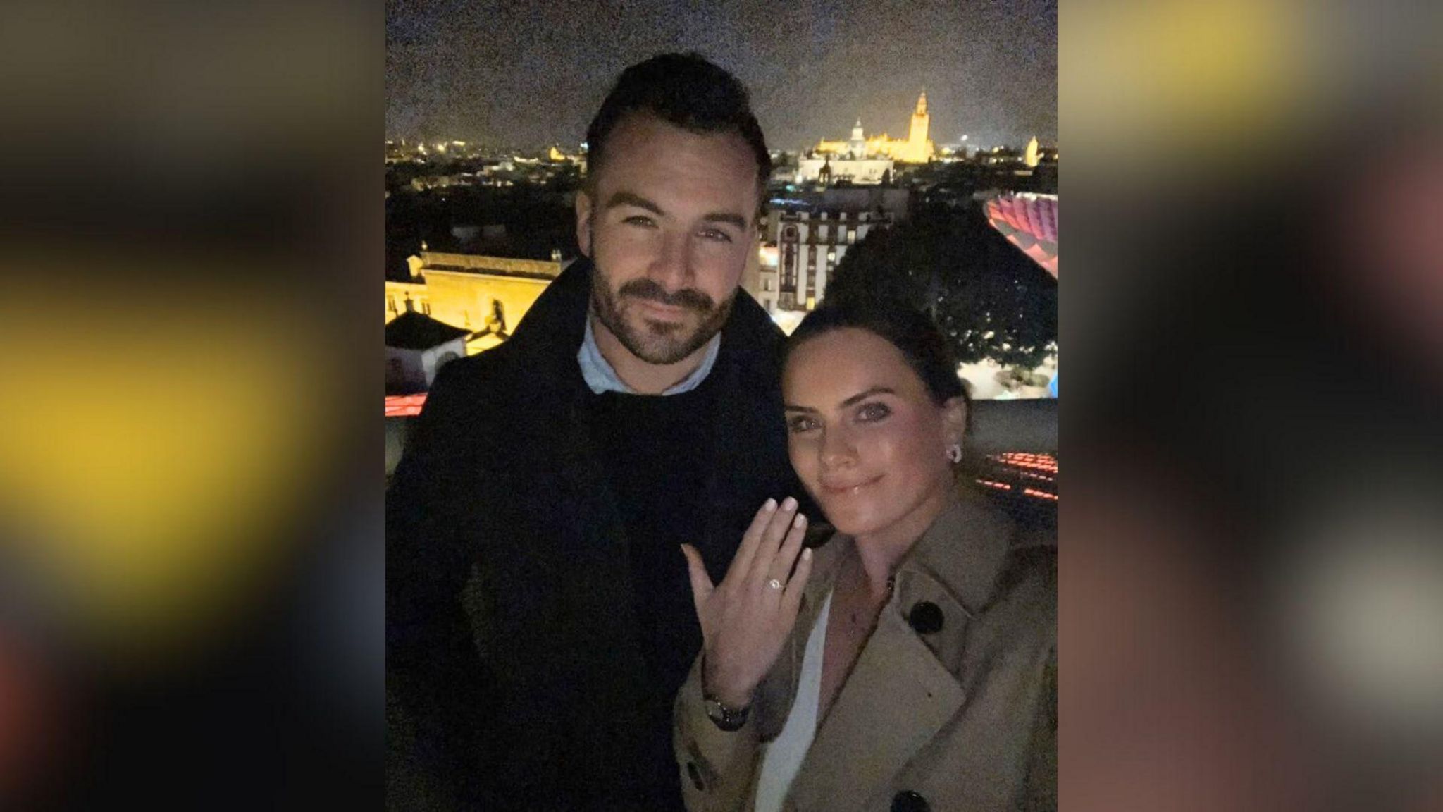 Couple holding up engagement ring