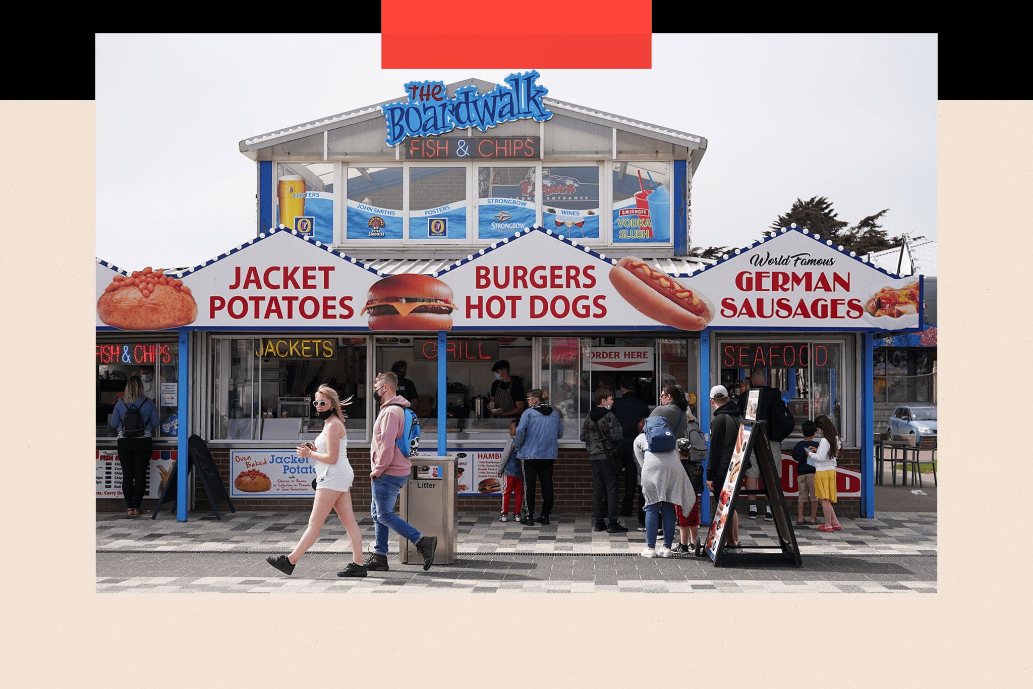 People queue outside a fast food kiosk on the promenade in Skegness