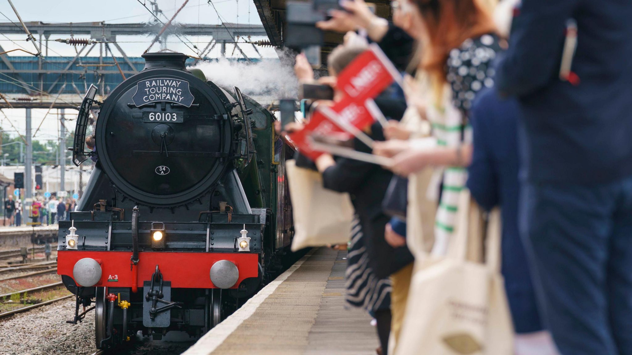People wave flags as Flying Scotsman visits Doncaster in 2023