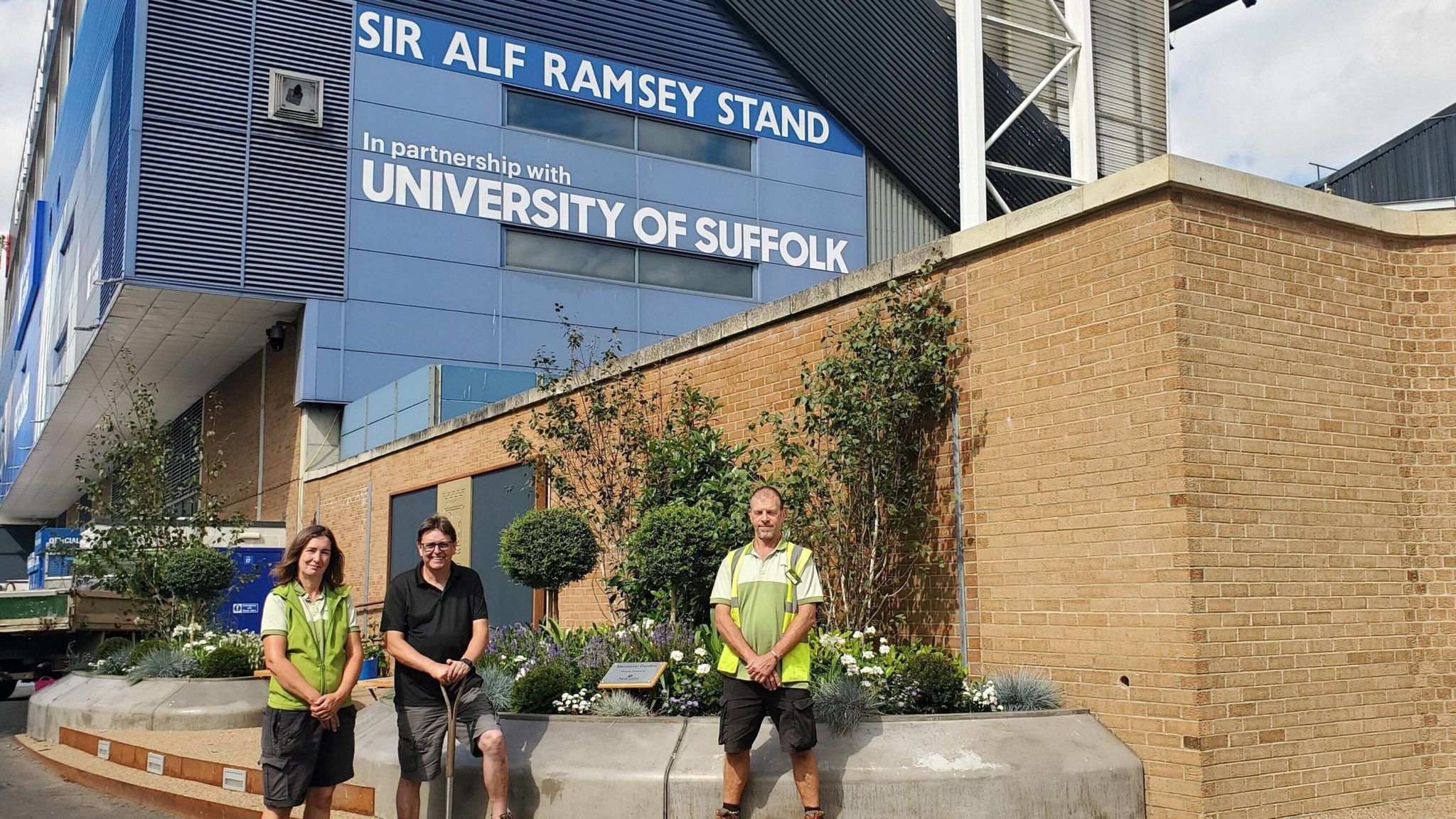 Notcutts staff in front of the memorial