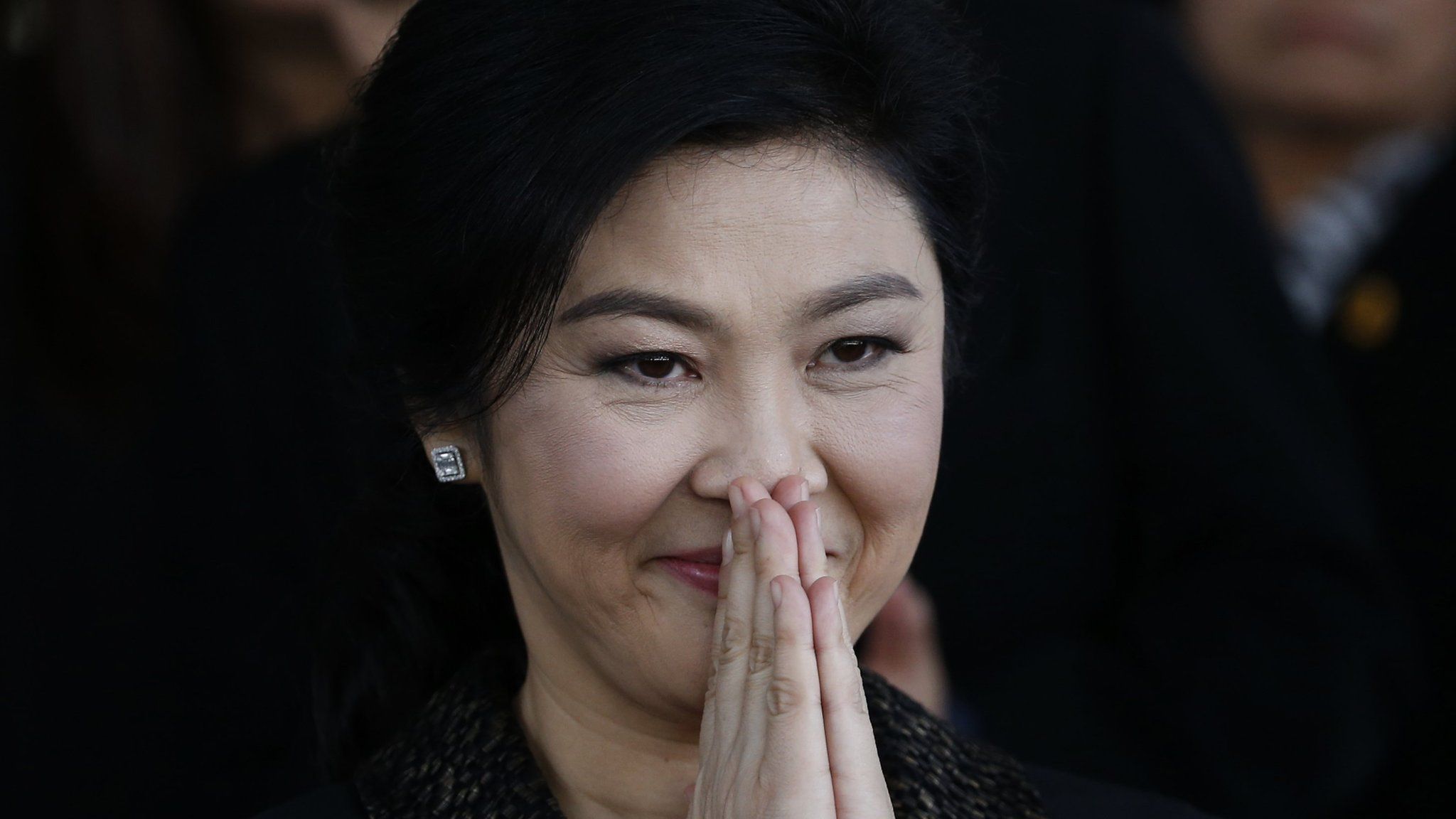 Former Thai prime minister Yingluck Shinawatra greets her supporters as she leaves the Supreme Court in Bangkok on 1 Aug 2017