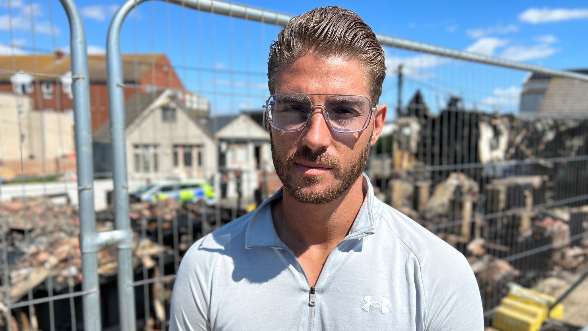 Aaron Taylor standing in front of the properties affected by a fire in Jaywick