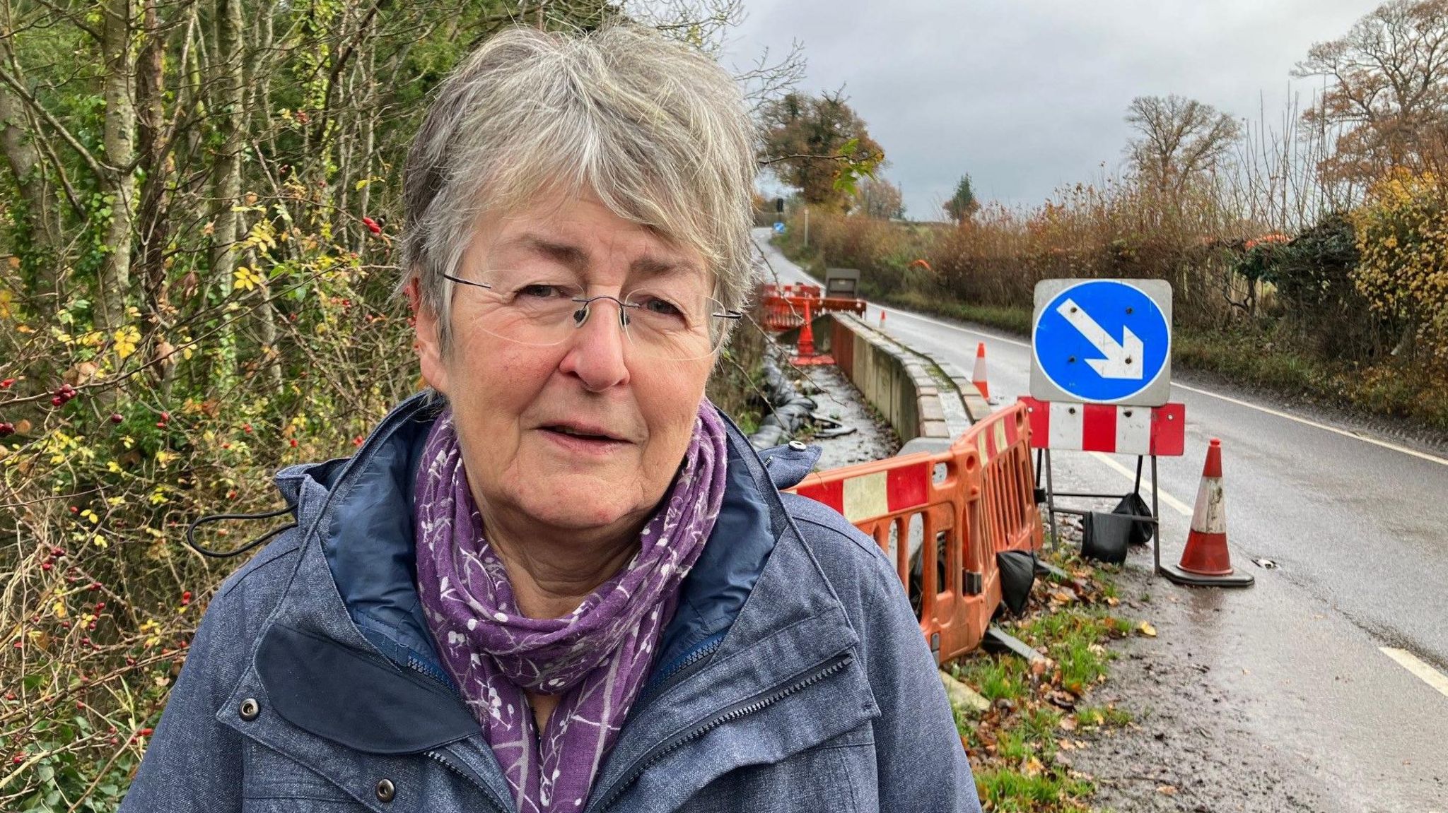 Councillor standing in front of landslip