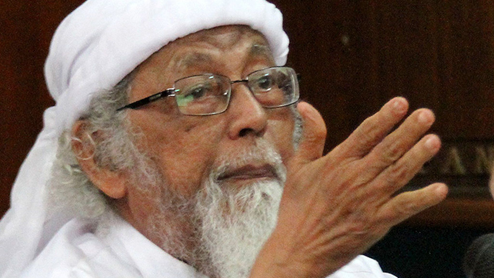 File photo taken on February 9, 2016 shows jailed Indonesian cleric Abu Bakar Ba'asyir gesturing during a court appearance in Cilacap, Central Java