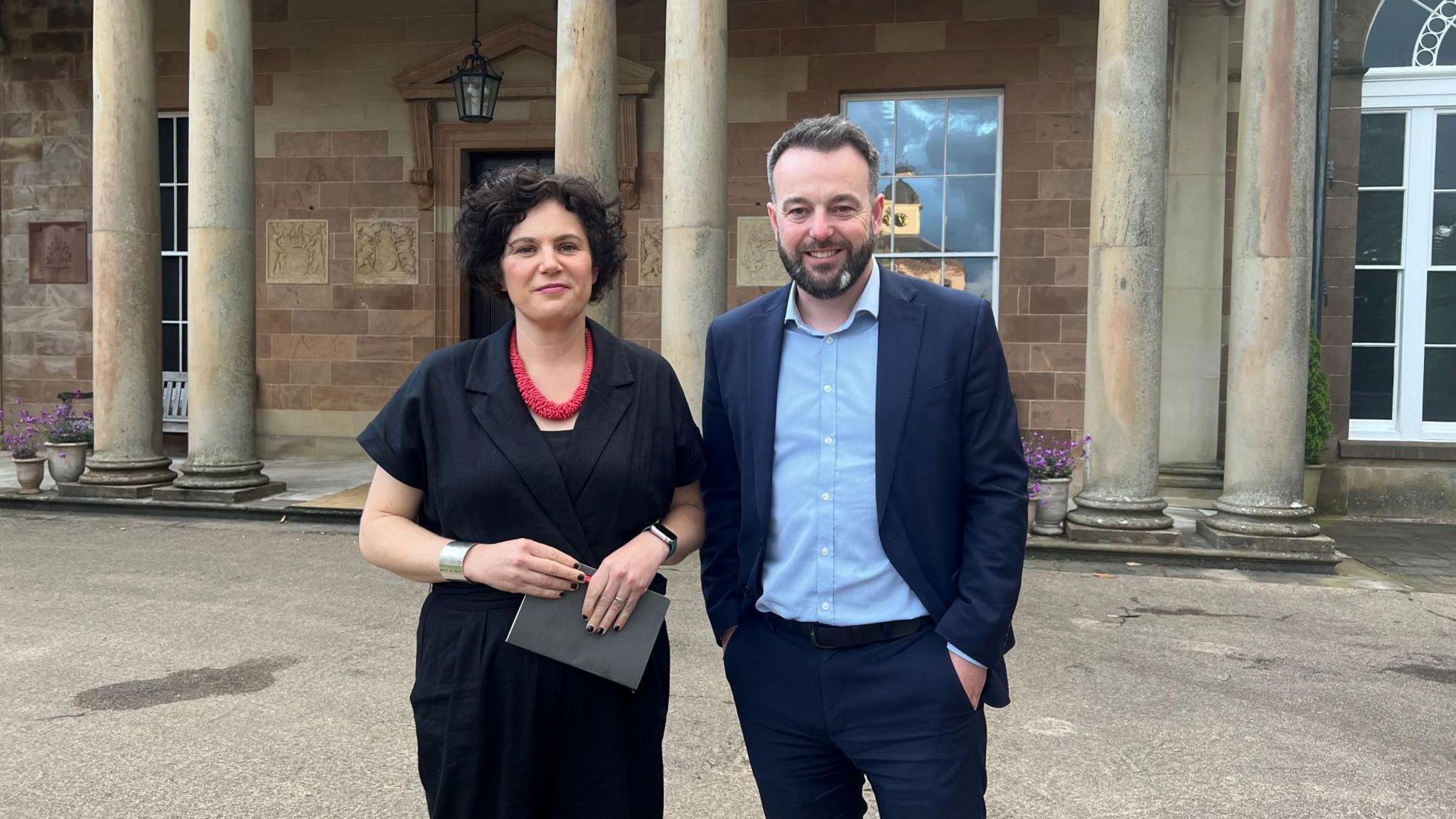 MPs Colum Eastwood and Claire Hanna stand outside Hillsborough Castle