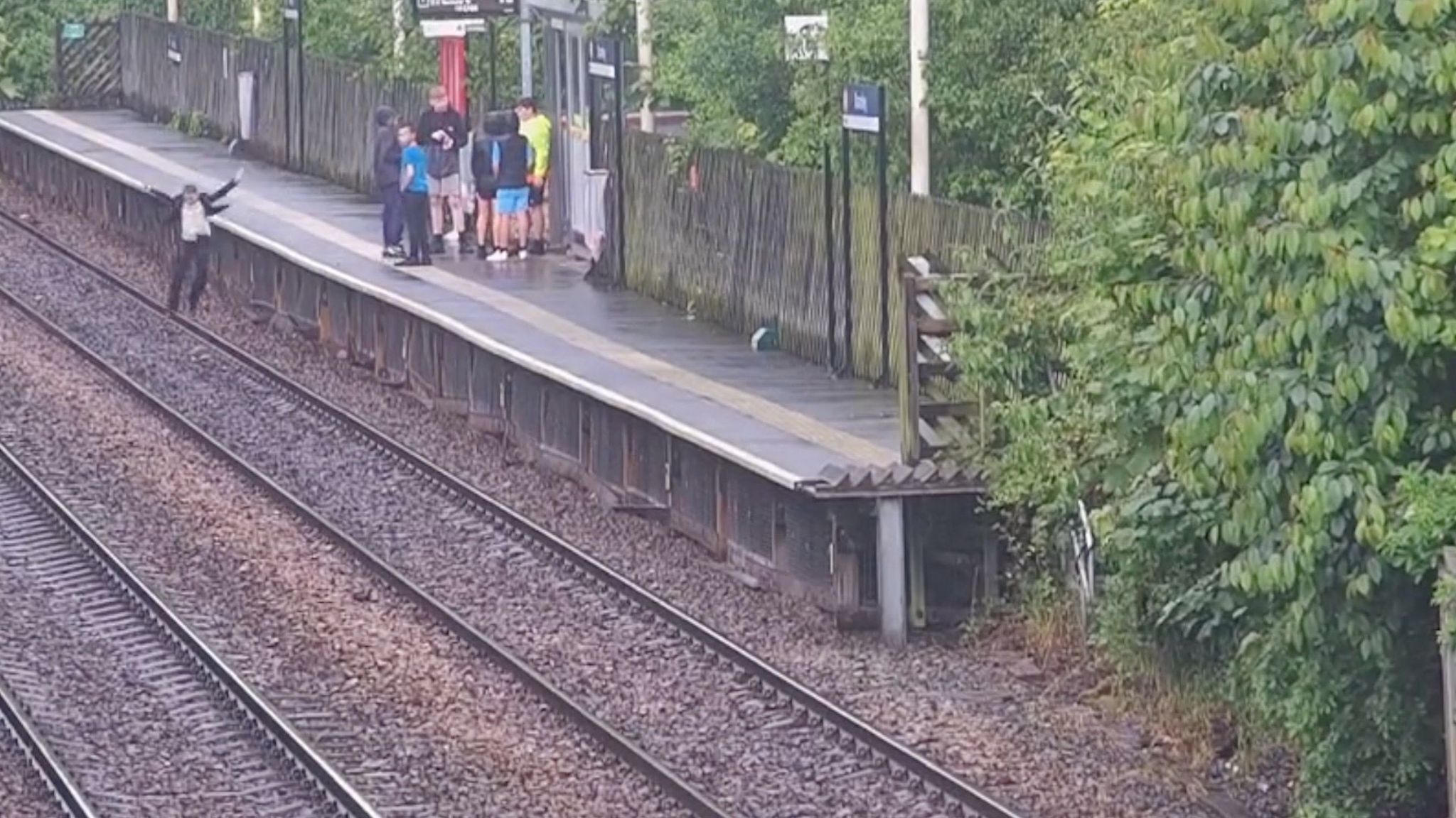 A young boy on the train tracks