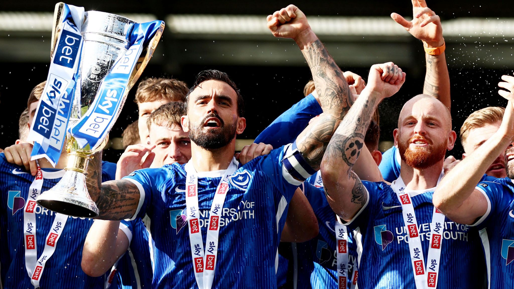 Marlon Pack lifts the League One winners trophy with his teammates