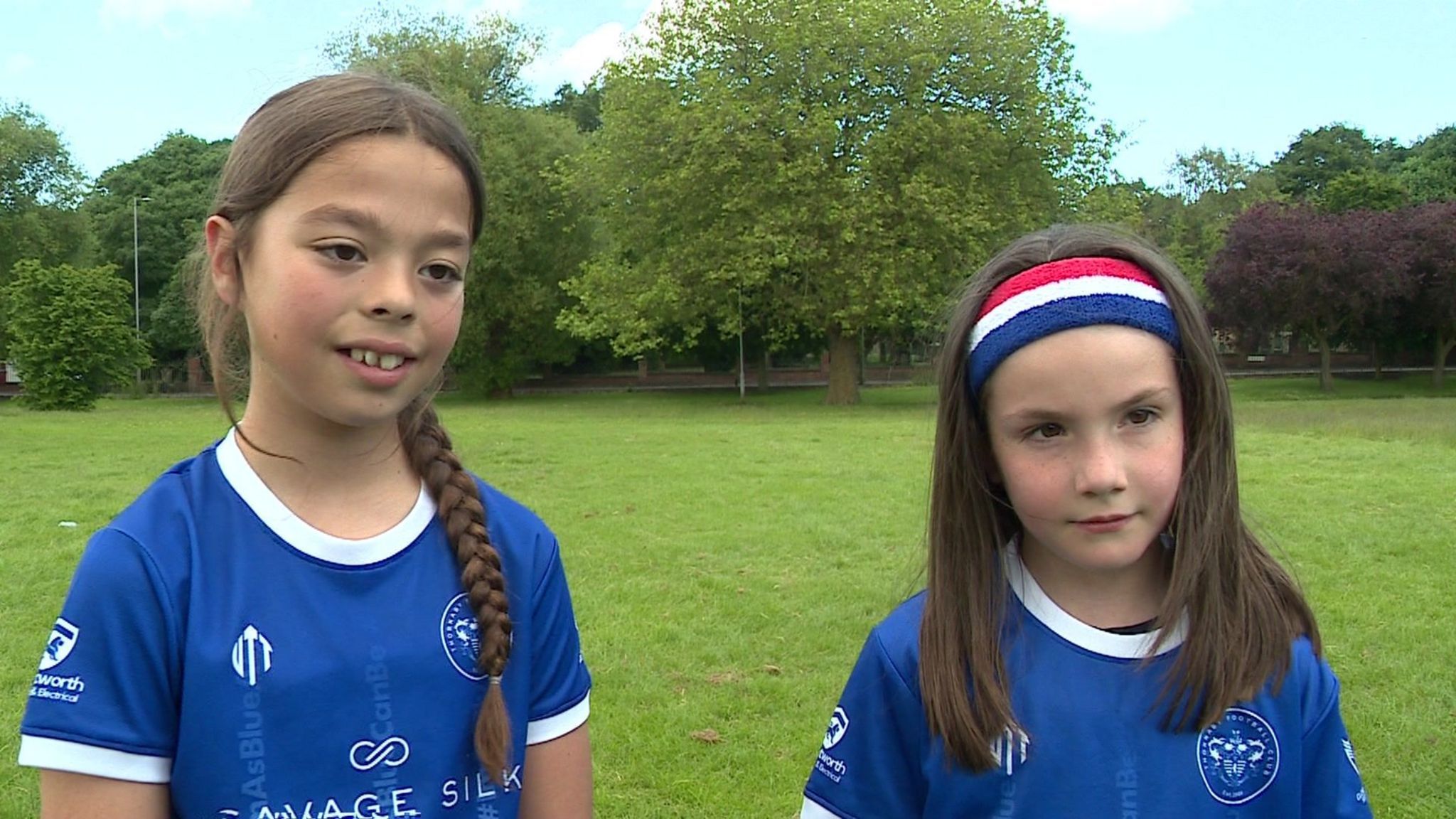 Isla (left) and Mia (right) being interviewed in their blue club shirts