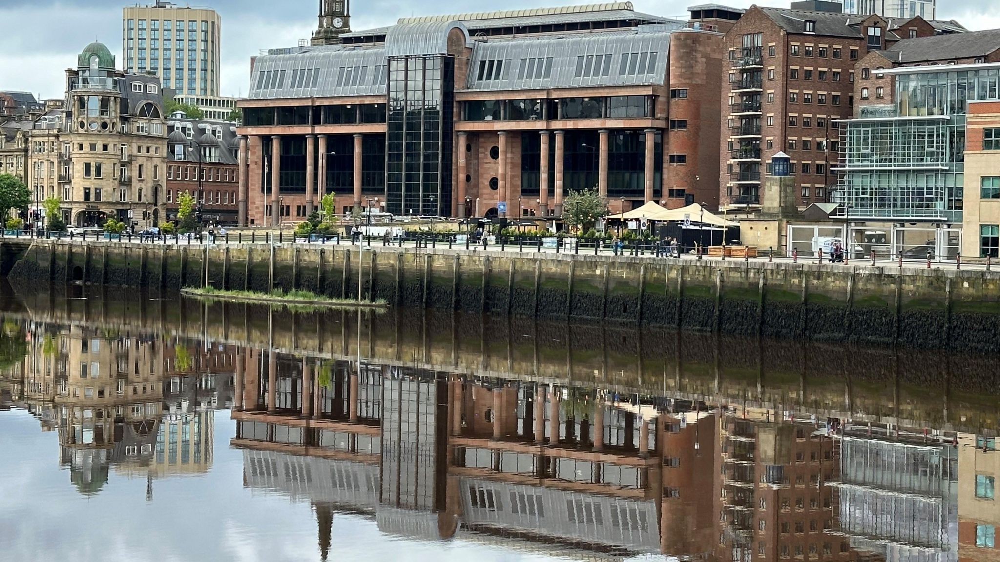 Court building reflected in river
