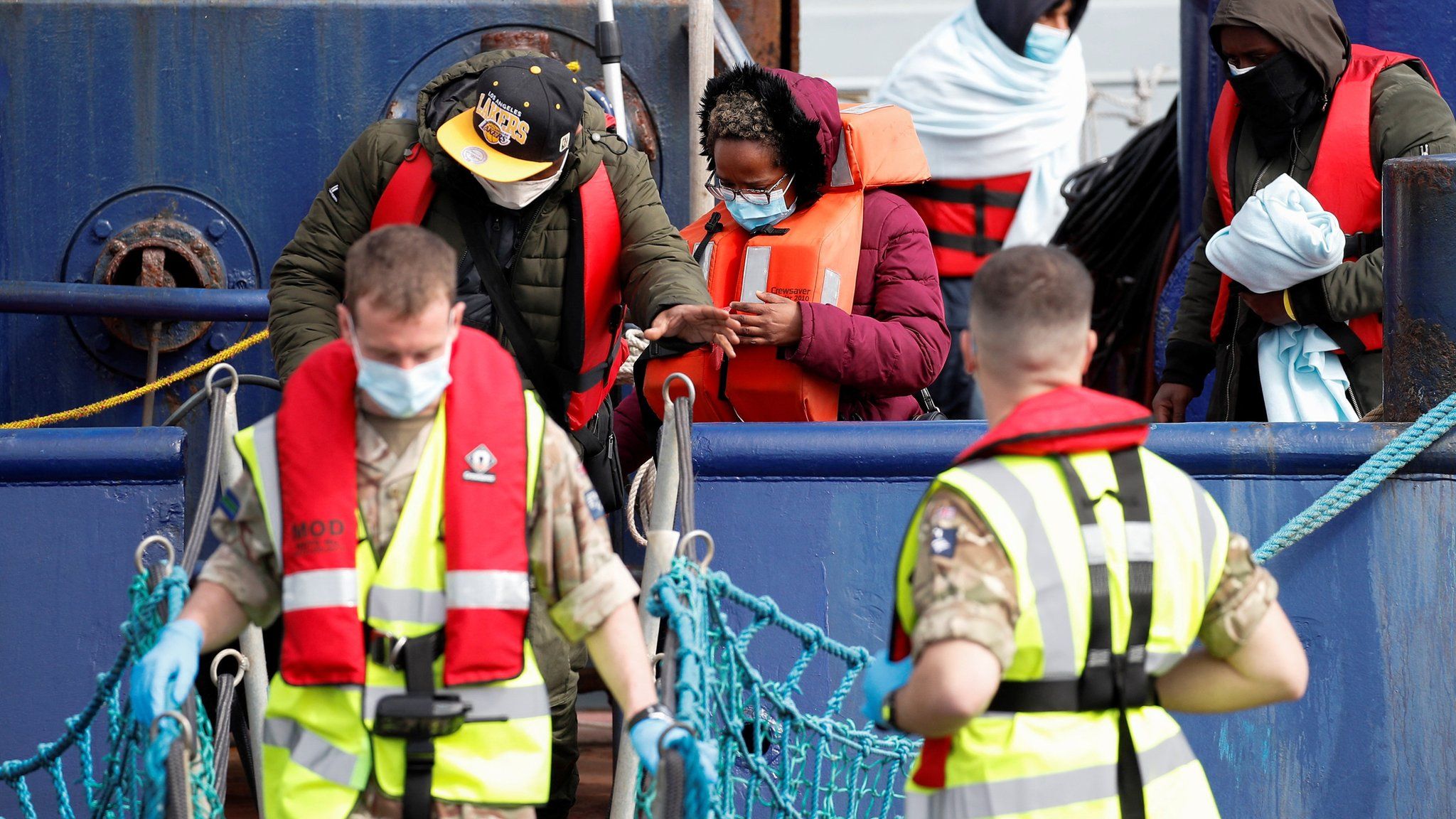 Migrants arrive in Dover on Thursday after being rescued while crossing the English Channel