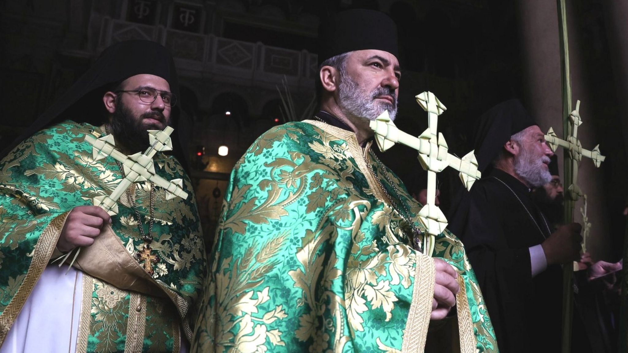 Greek Orthodox monks hold palm crosses during an Orthodox Palm Sunday procession in Jerusalem on 9 April 2023