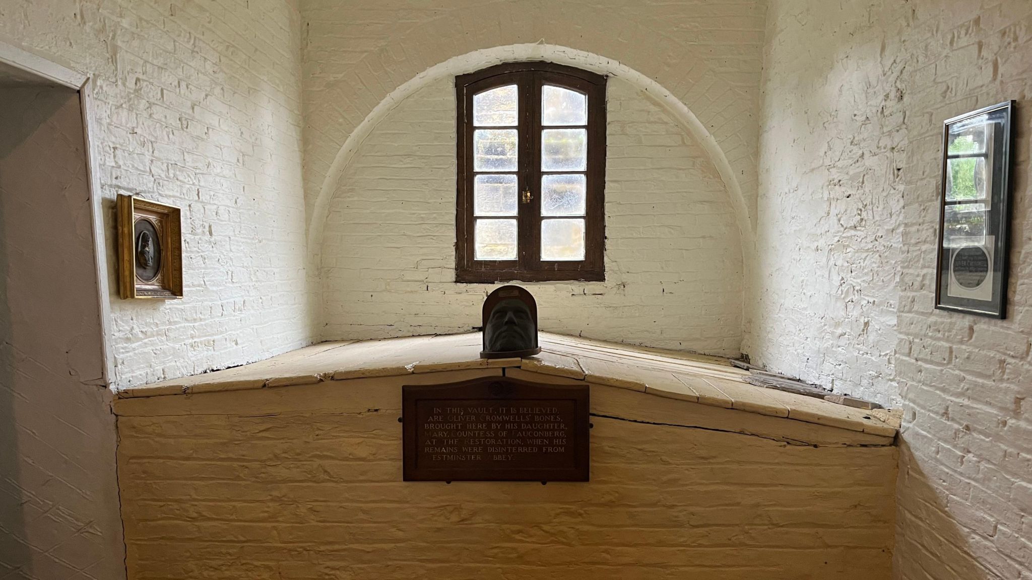 Tomb under window with painted walls