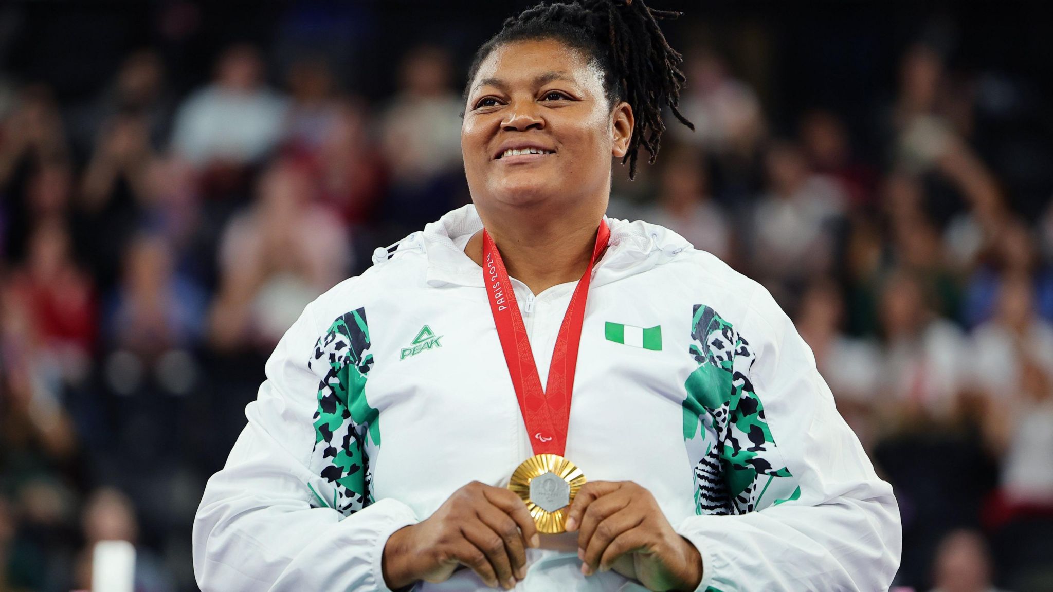 Folashade Oluwafemiayo celebrates with her gold medal in Paris