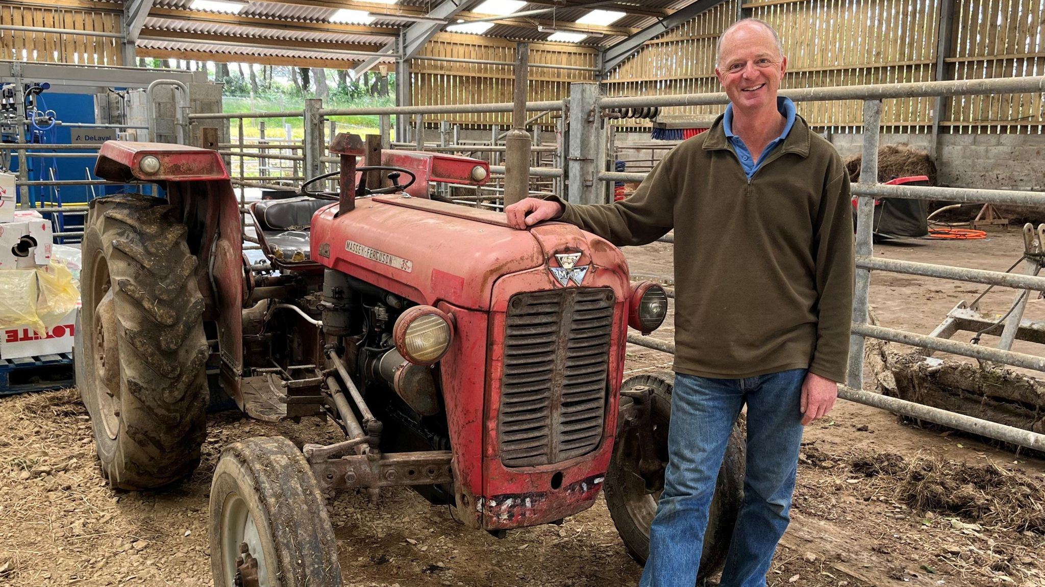 Jason Salisbury beside a tractor at Sark Dairy