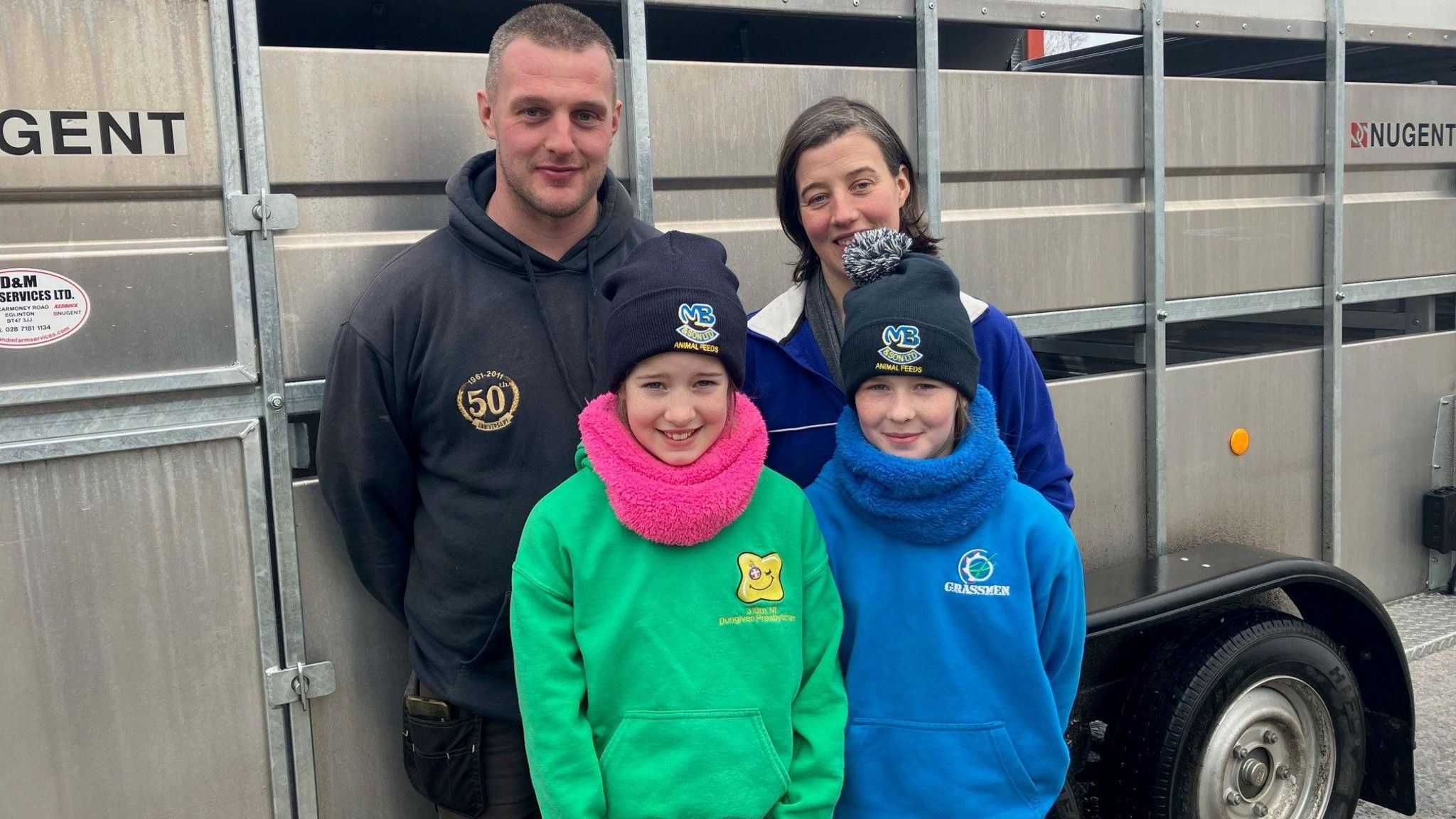 Alan and Lynn Keatley pictured with nieces in front of farm trailer