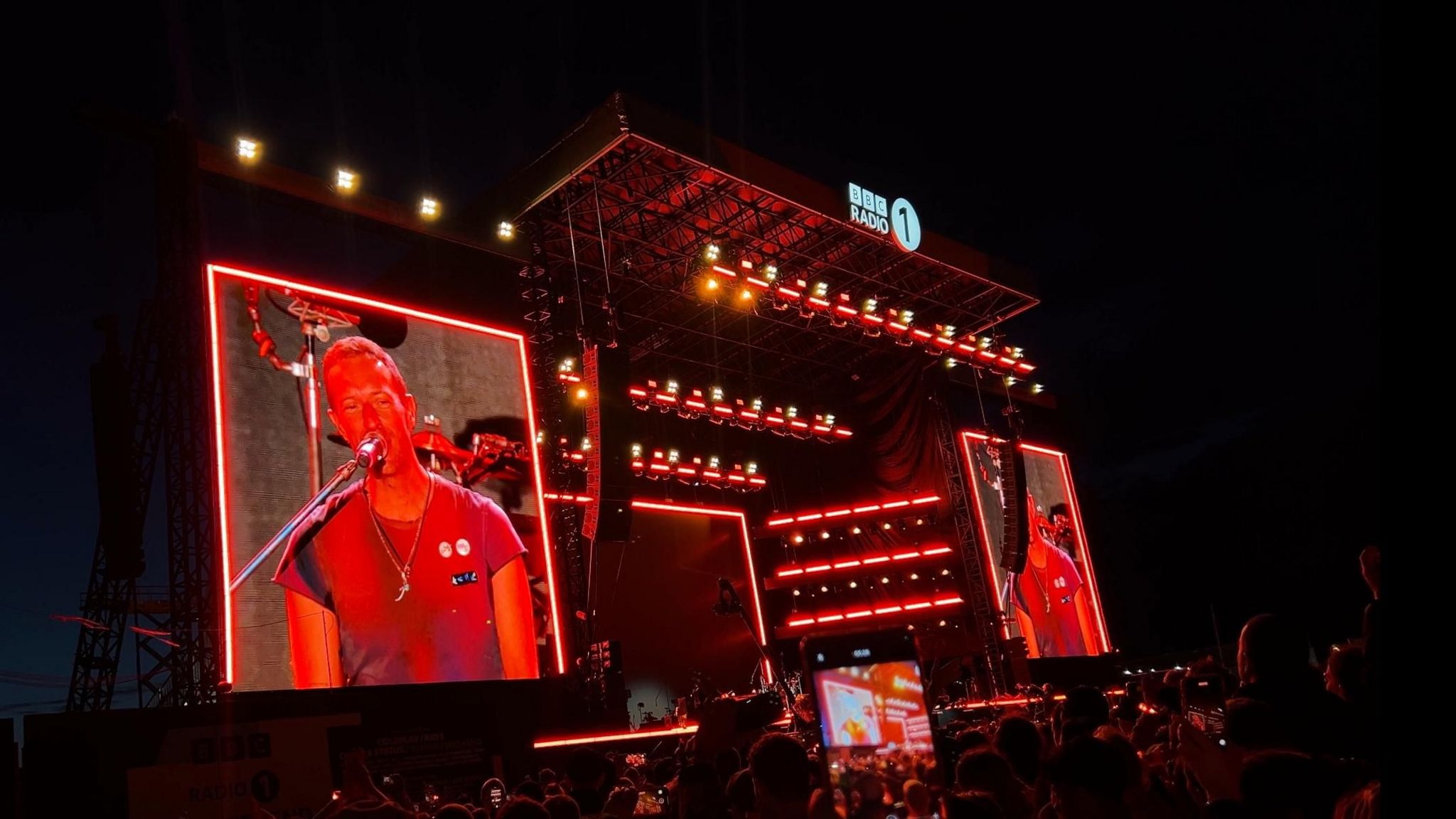 Coldplay on stage at Big Weekend with Orange lights