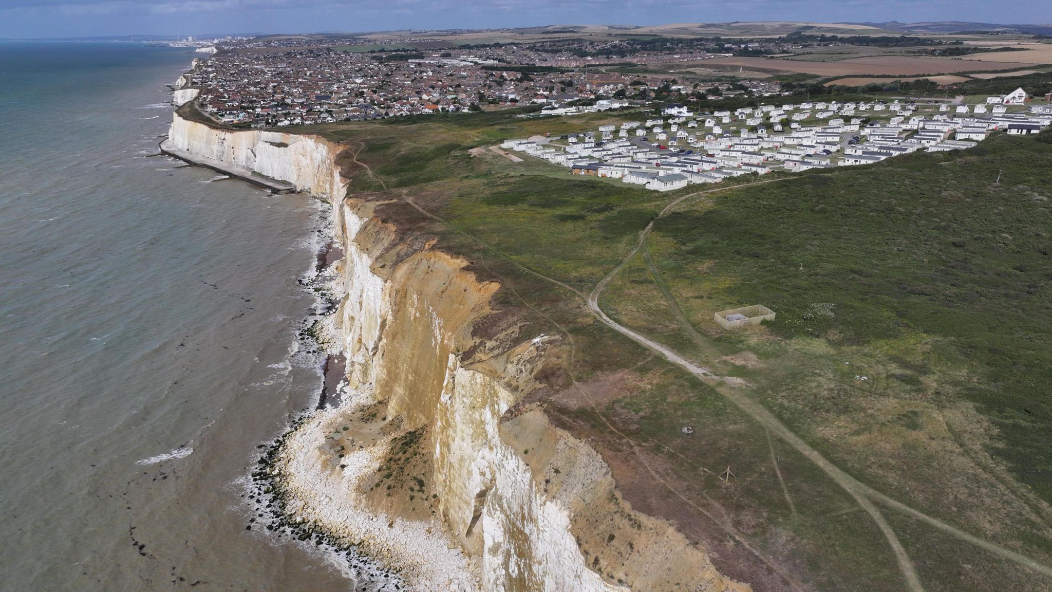 A drone picture of the cliff fall with Peacehaven in the background