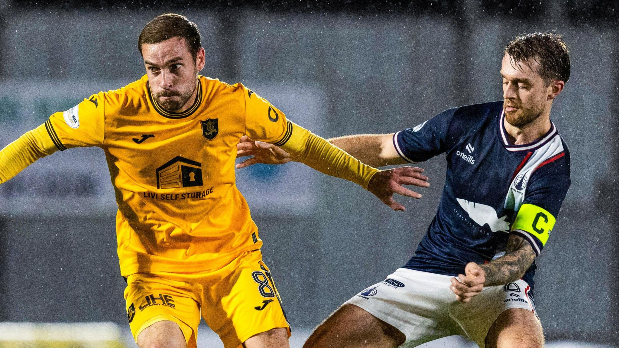 Livingston's Scott Pittman (L) and Falkirk's Brad Spencer in action during a William Hill Championship match between Falkirk and Livingston at the Falkirk Stadium,