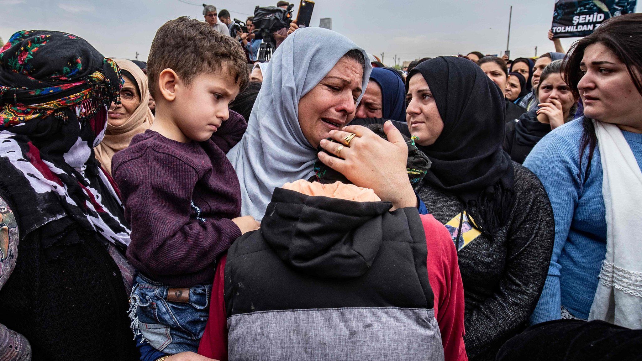 Mourners attend the funerals in Qamishli, Syria, of three Syrian Democratic Forces fighters killed in Ras al-Ain (24 October 2019)