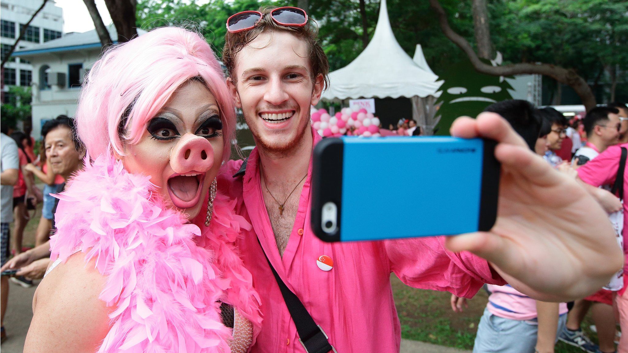 Participants dress in various shades of pink take a selfie during the 'Pink Dot SG' event at Hong Lim Park on June 13, 2015 in Singapore.