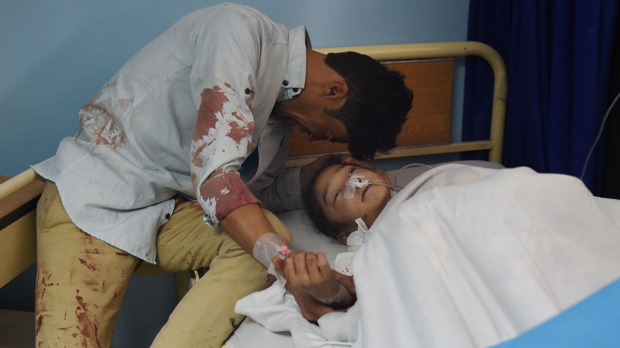 Wounded Afghan child Zahra, 8, is treated following a suicide bombing attack at the Isteqlal Hospital in Kabul on April 22, 2018