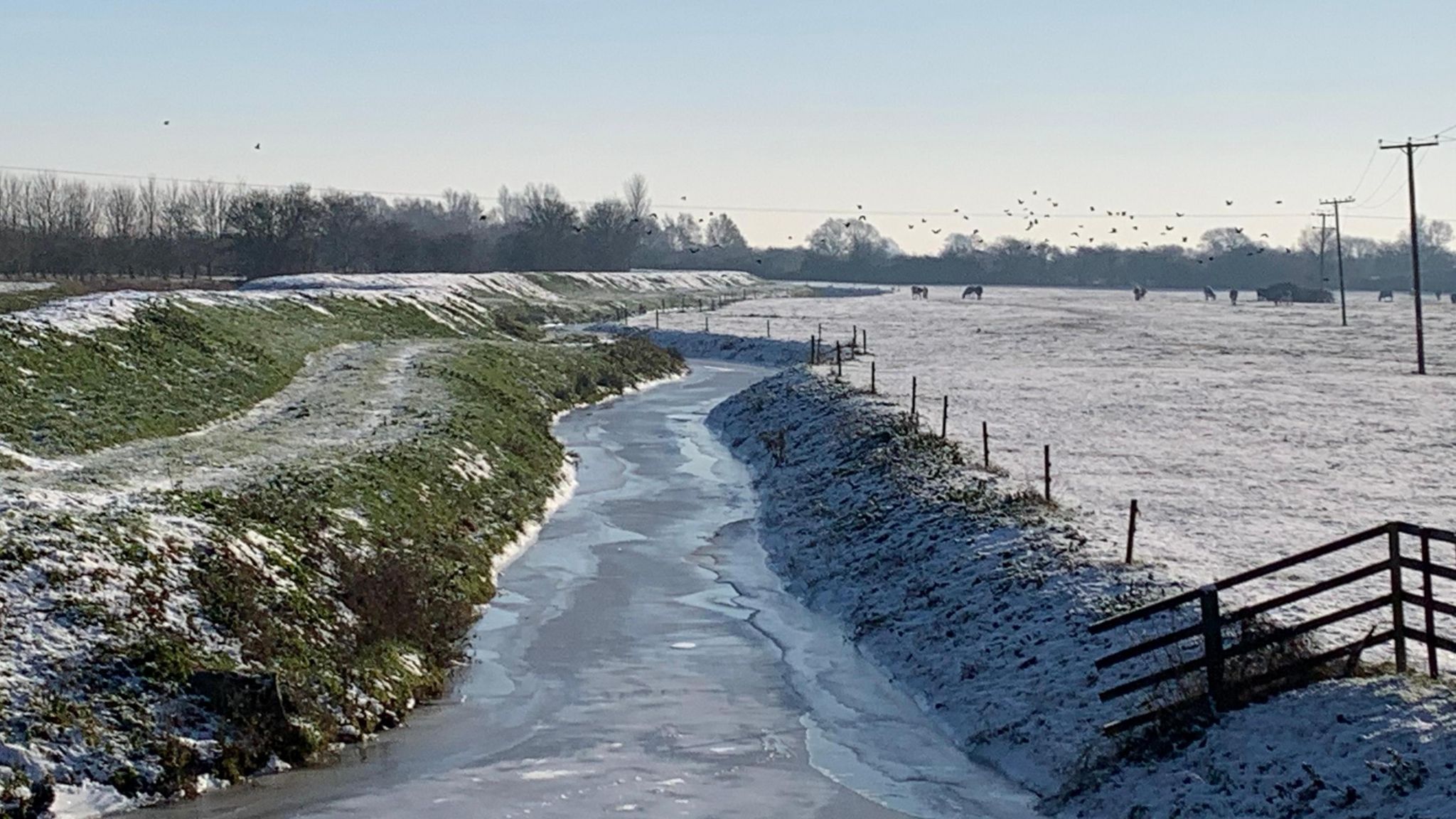 Frozen river and snow covered fields