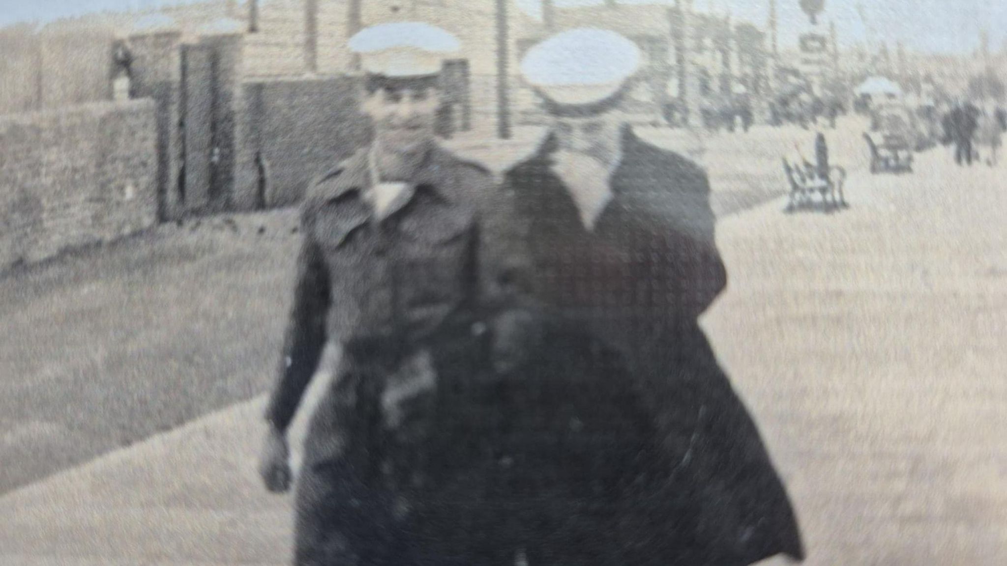 A blurred black and white image of Ron Cunningham with another sailor 