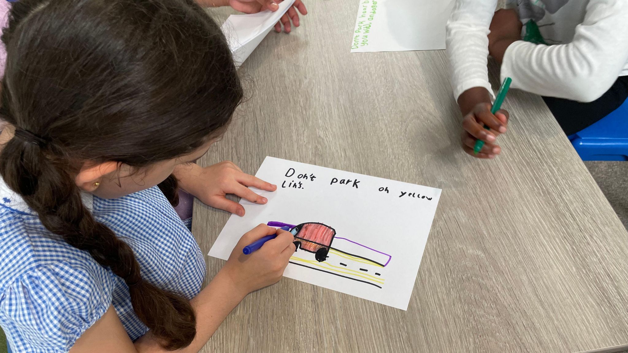 Children making posters inside school