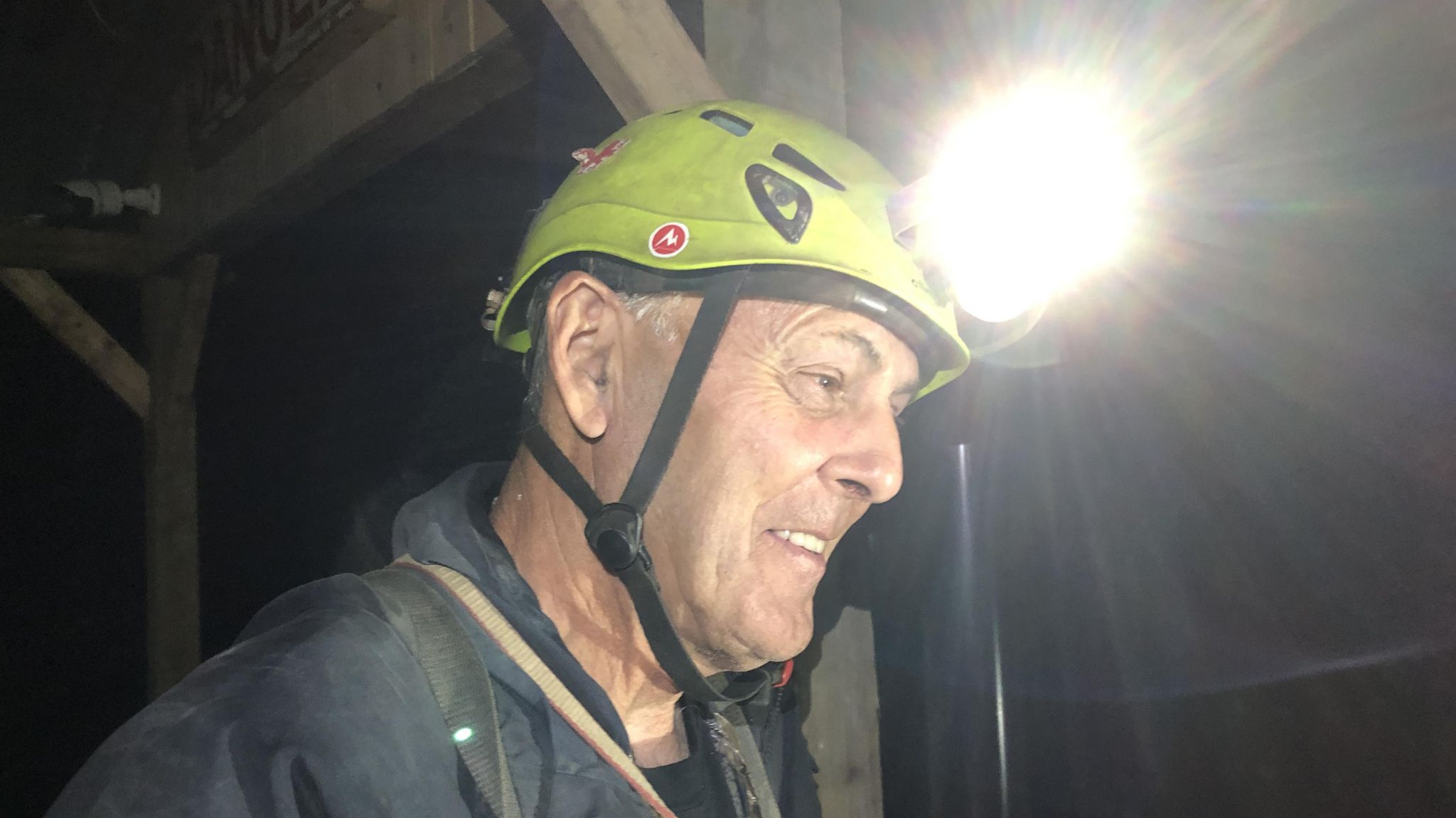 Peredur Hughes underground at Cwmorthin mine, wearing a helmet and light