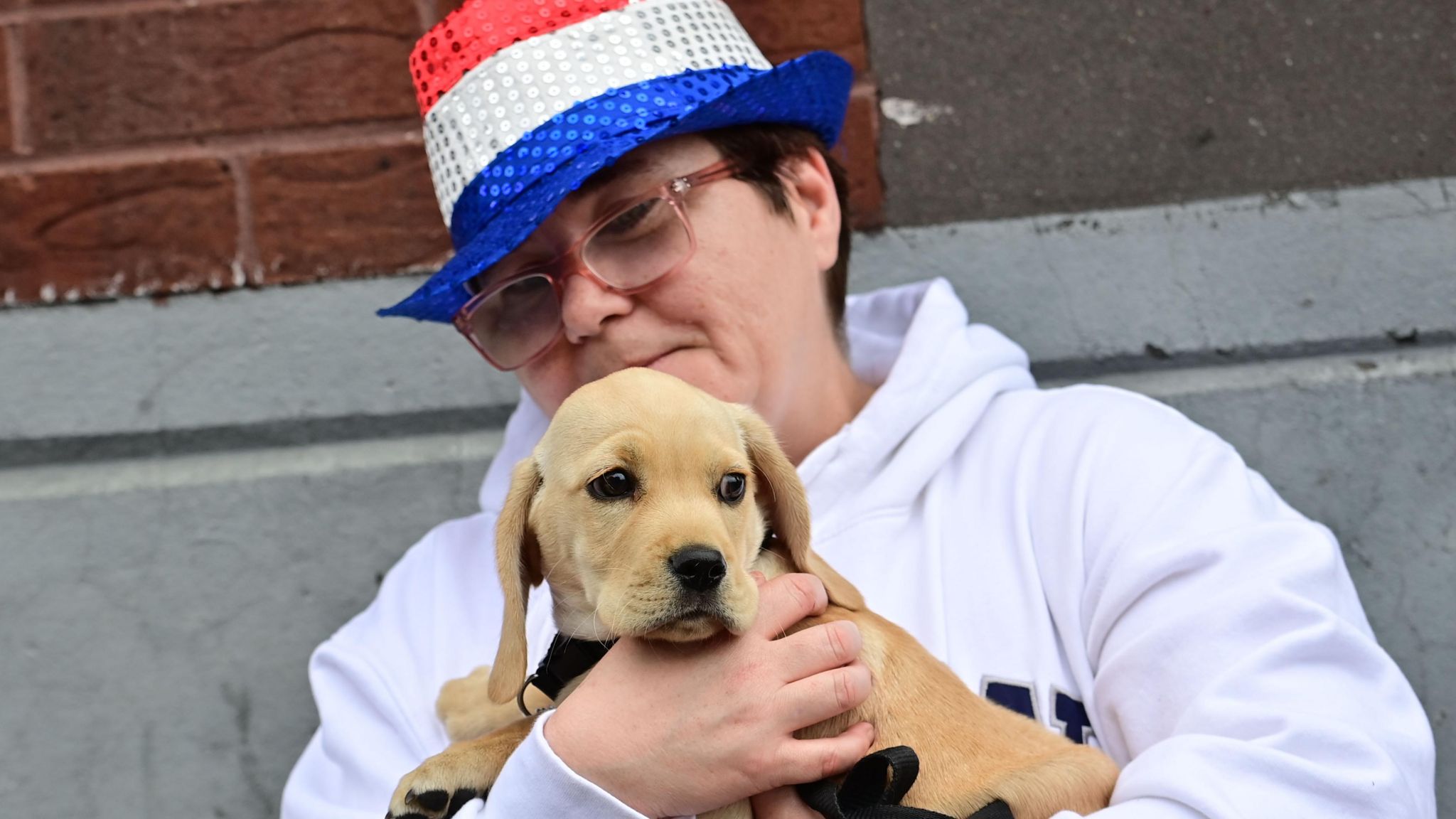 Woman watching parade with puppy