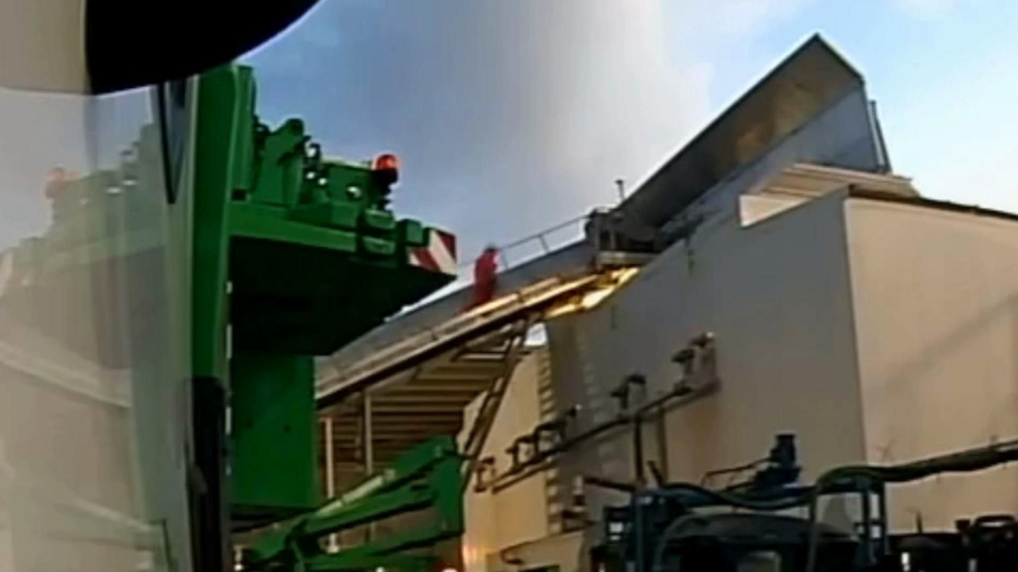 Screengrab from CCTV footage of an engineer wearing red overalls climbing a stairwell before he falls.