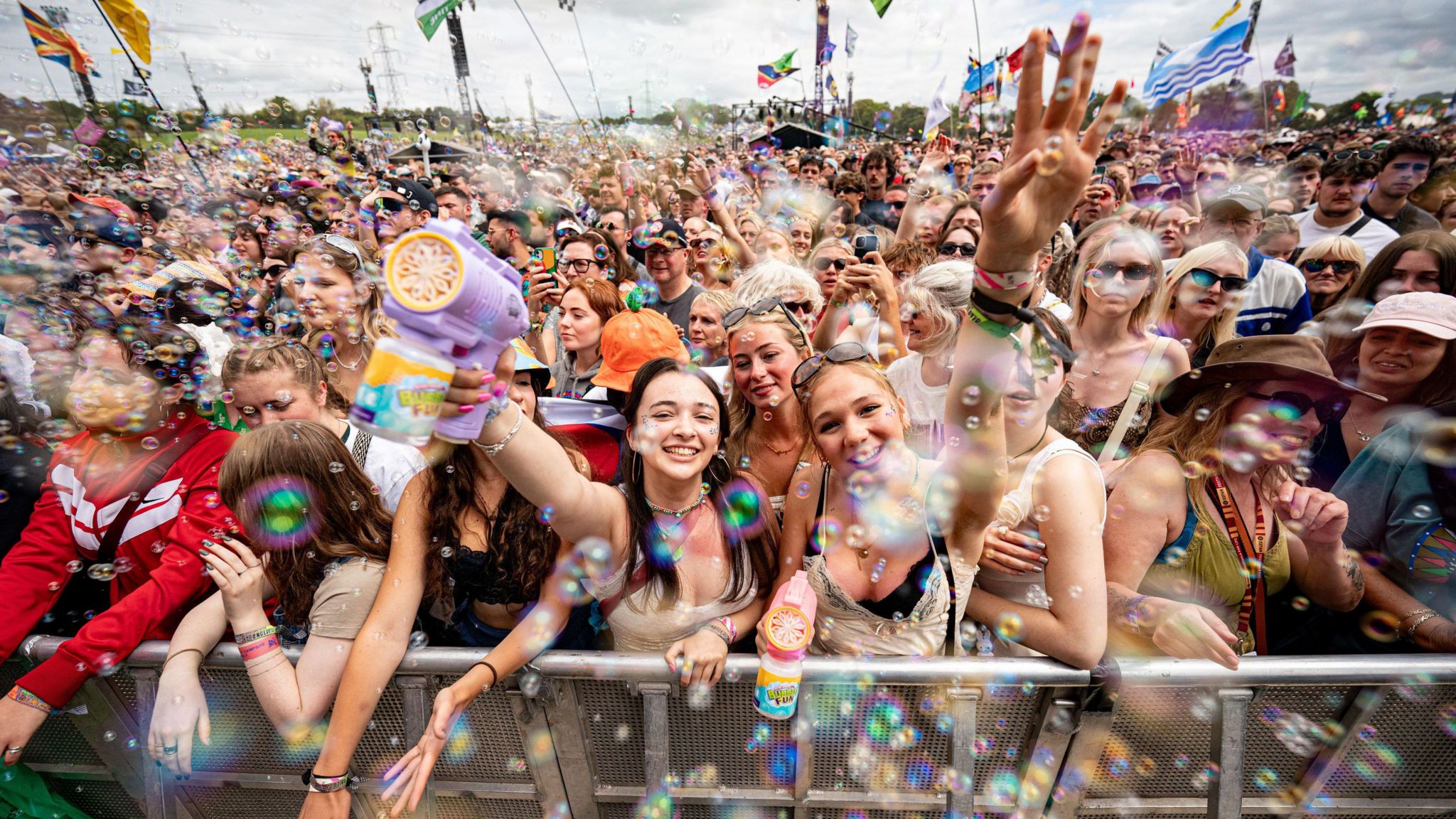 A crowd dancing amongst bubbles at the Glastonbury Festival