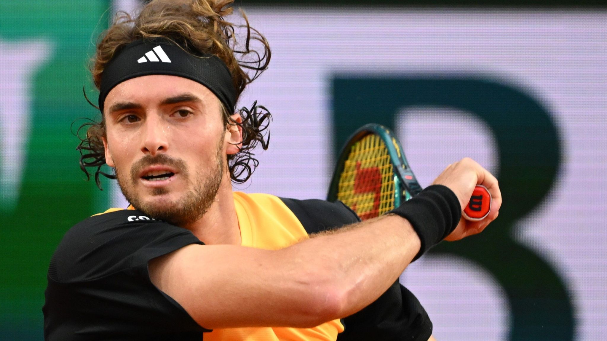 Stefanos Tsitsipas hits a backhand