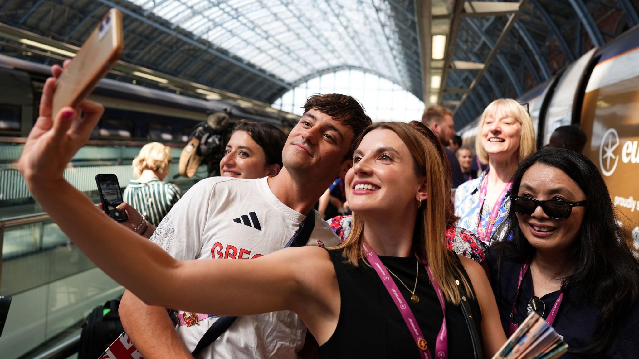 Tom Daley posing for a photo at St Pancras