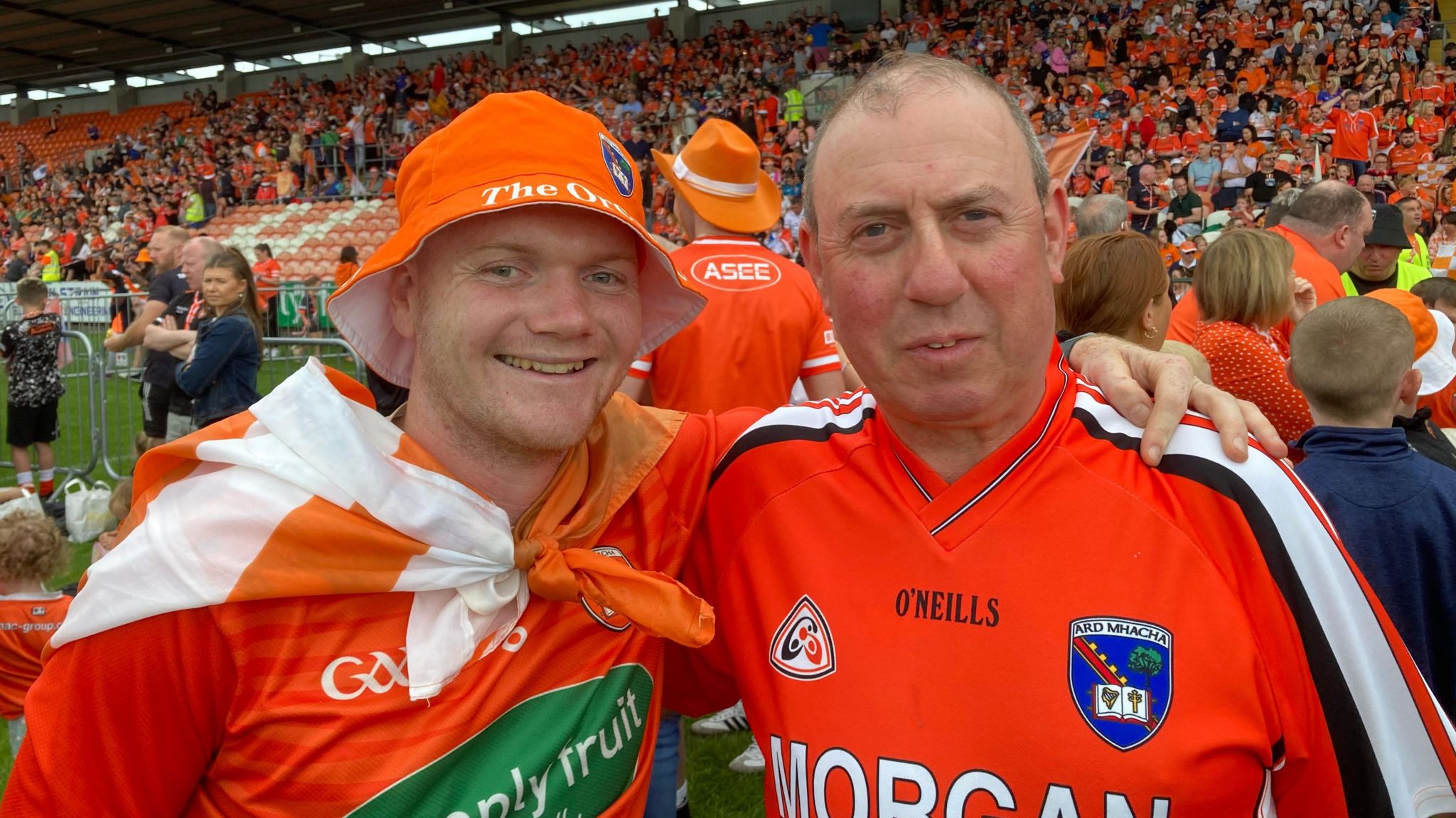 Two men in orange Armagh jerseys