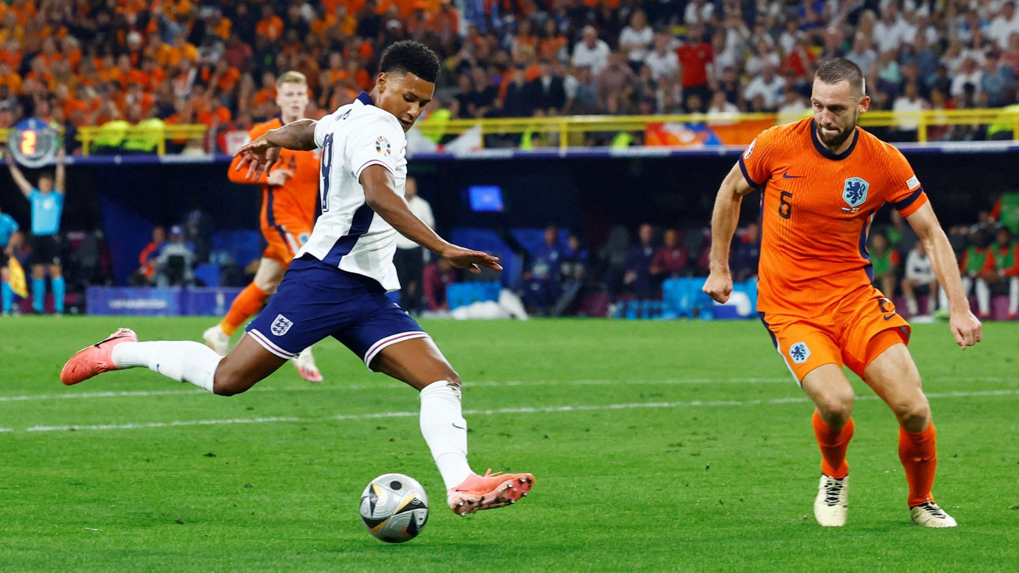 Watkins aims to kick football past a Netherlands player