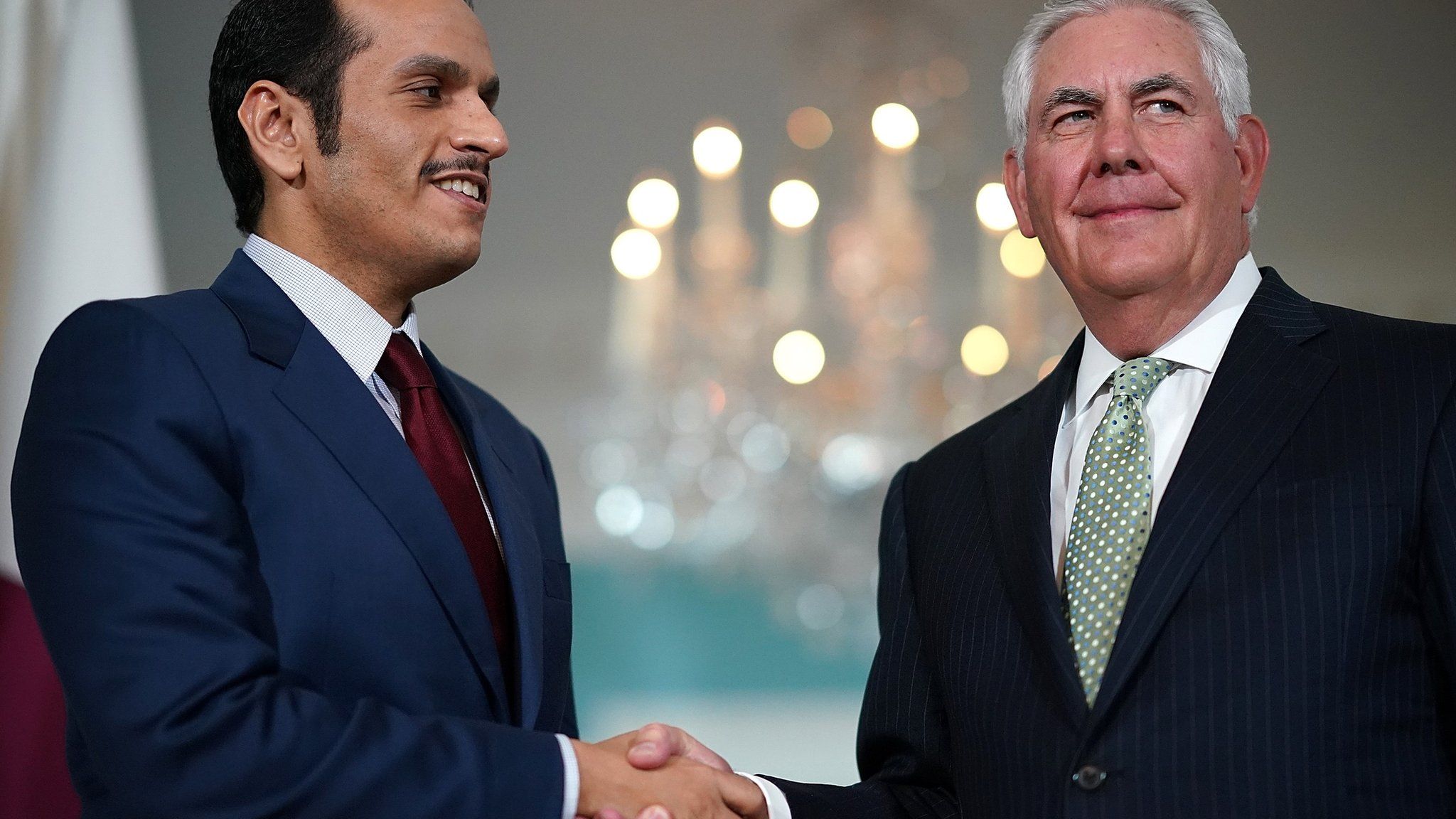 Qatari Foreign Minister Sheikh Mohammed Bin Abdul Rahman Al Thani shakes hands with US Secretary of State Rex Tillerson at the state department in Washington on 27 June 2017
