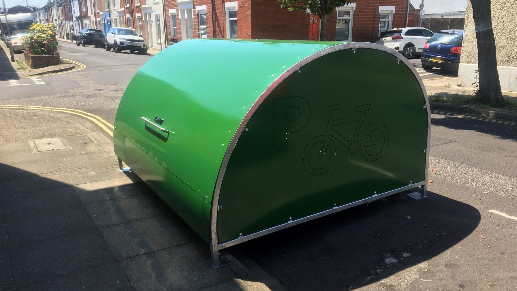 Bright green bike hangar on the road in a street in portsmouth